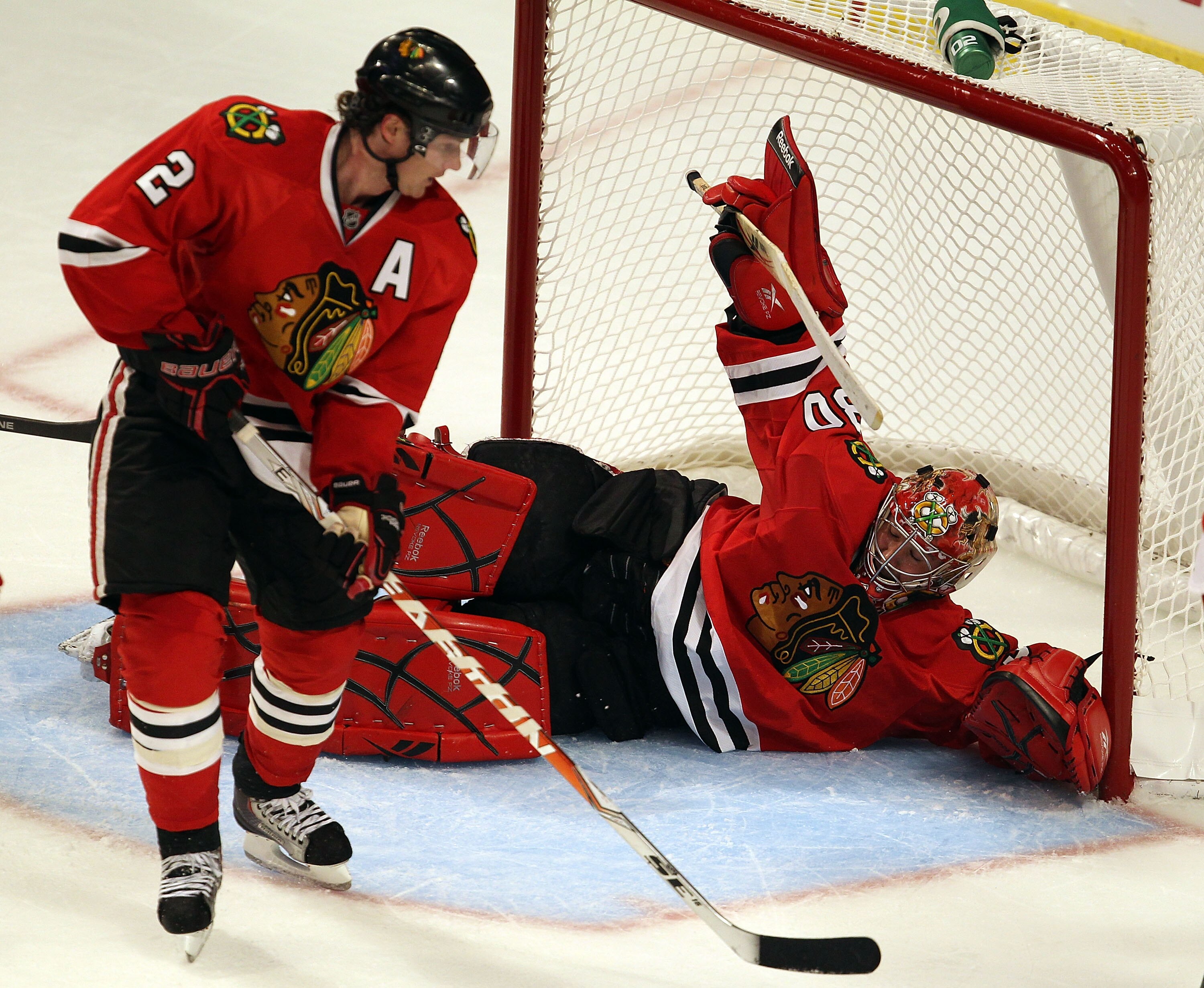 CHICAGO - OCTOBER 09: Marty Turco #30 of the Chicago Blackhawks sprawls to make a save in front of teammate Duncan Keith #2 against the Detroit Red Wings during the Blackhawks season home opening game at the United Center on October 9, 2010 in Chicago, Il CHICAGO - OCTOBER 09: Marty Turco #30 of the Chicago Blackhawks sprawls to make a save in front of teammate Duncan Keith #2 against the Detroit Red Wings during the Blackhawks season home opening game at the United Center on October 9, 2010 in Chicago, Il