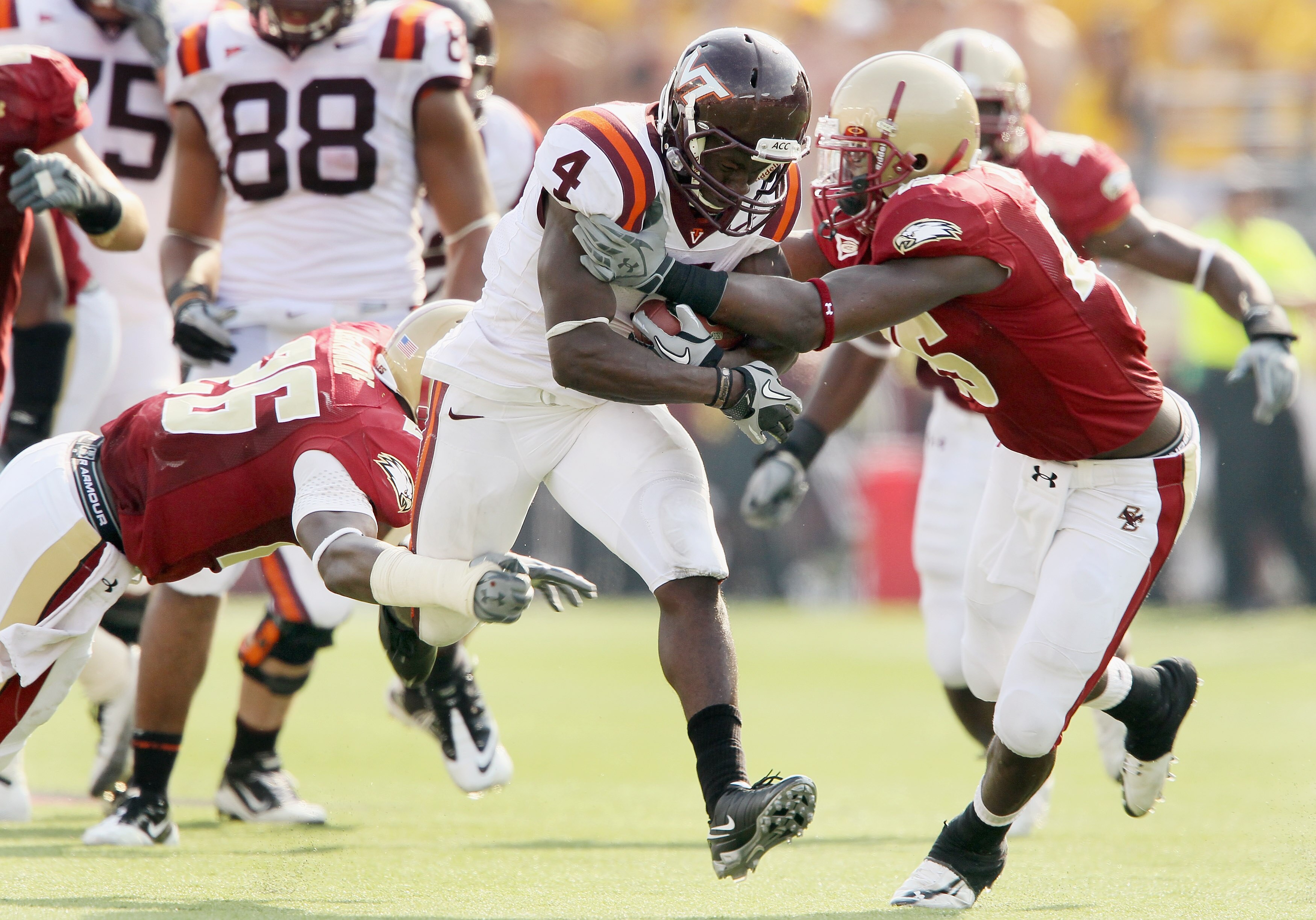 CHESTNUT HILL, MA - SEPTEMBER 25:  David Wilson #4 of the Virginia Tech Hokies carries the ball as Dominick LeGrande #26 and Wes Davis #45 of the Boston College Eagles defend on September 25, 2010 at Alumni Stadium in Chestnut Hill, Massachusetts. Virgini