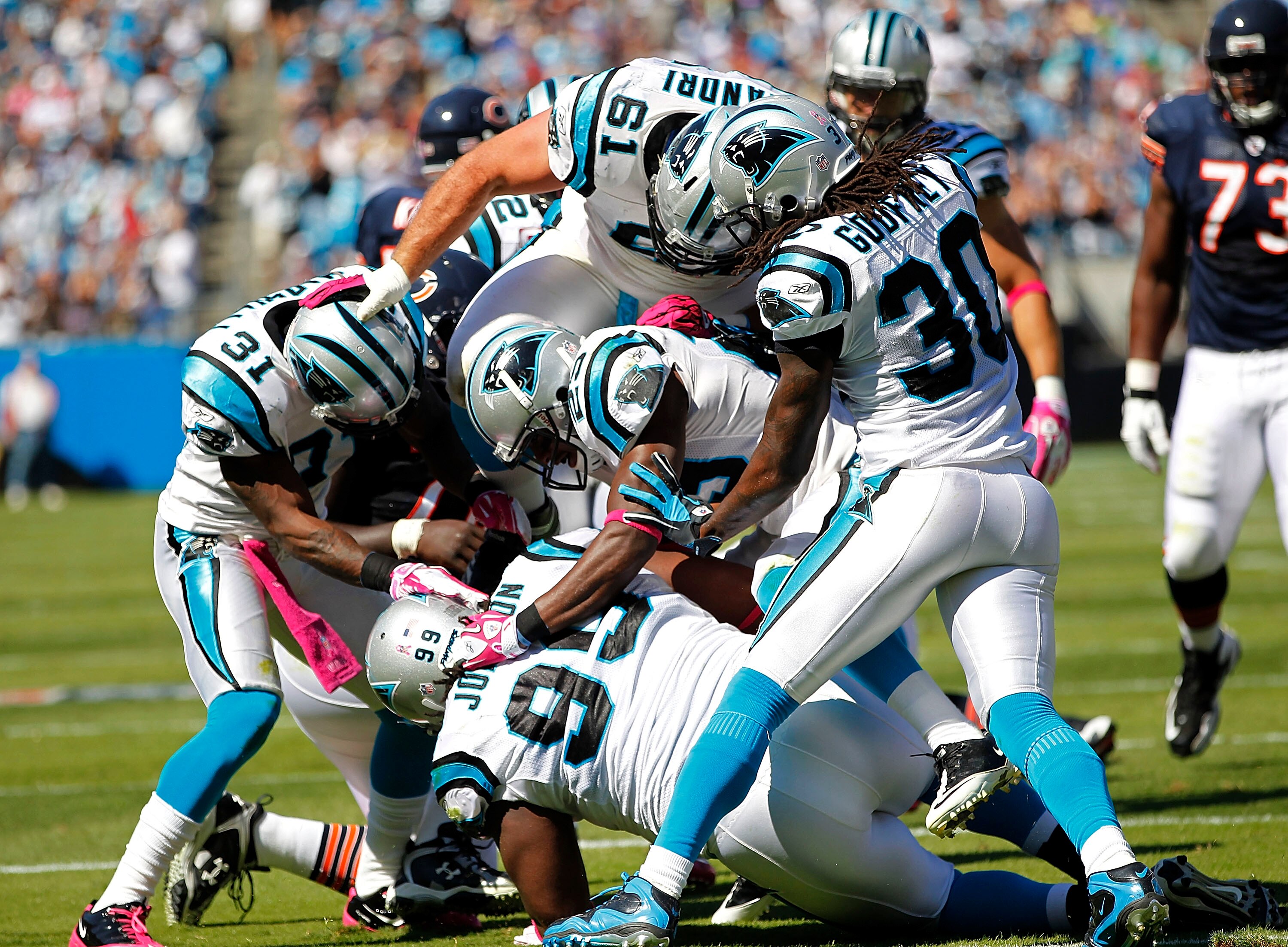 CHARLOTTE, NC - OCTOBER 10: Defensive tackle Ed Johnson #99 of the Carolina Panthers is mobbed by teammates after an interception against the Chicago Bears at Bank of America Stadium on October 10, 2010 in Charlotte, North Carolina. (Photo by Geoff Burke/
