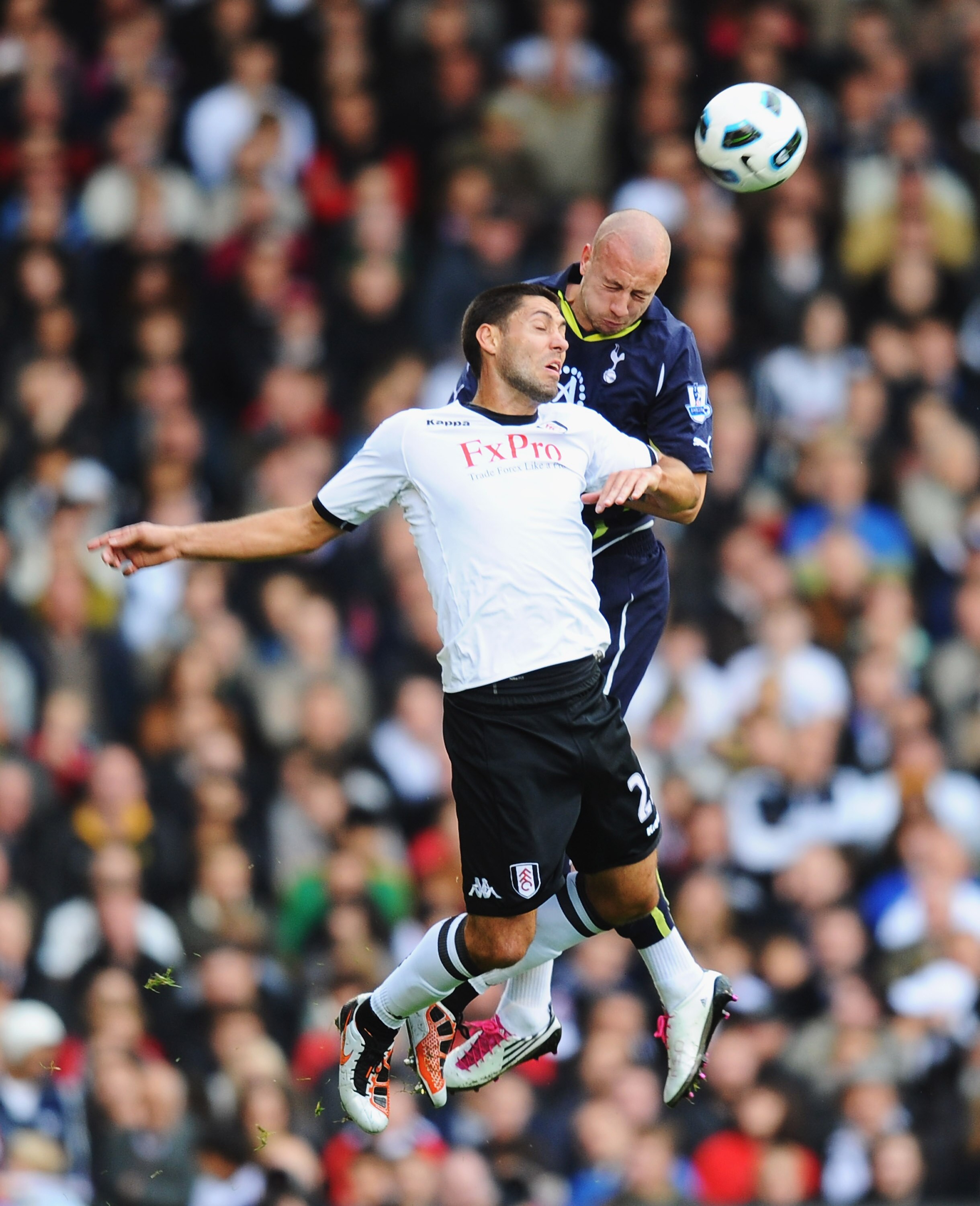 LONDON, ENGLAND - OCTOBER 16:  Alan Hutton of Tottenham is challenged by Clint Dempsey of Fulham during the Barclays Premier League match between Fulham and Tottenham Hotspur at Craven Cottage on October 16, 2010 in London, England.  (Photo by Mike Hewitt