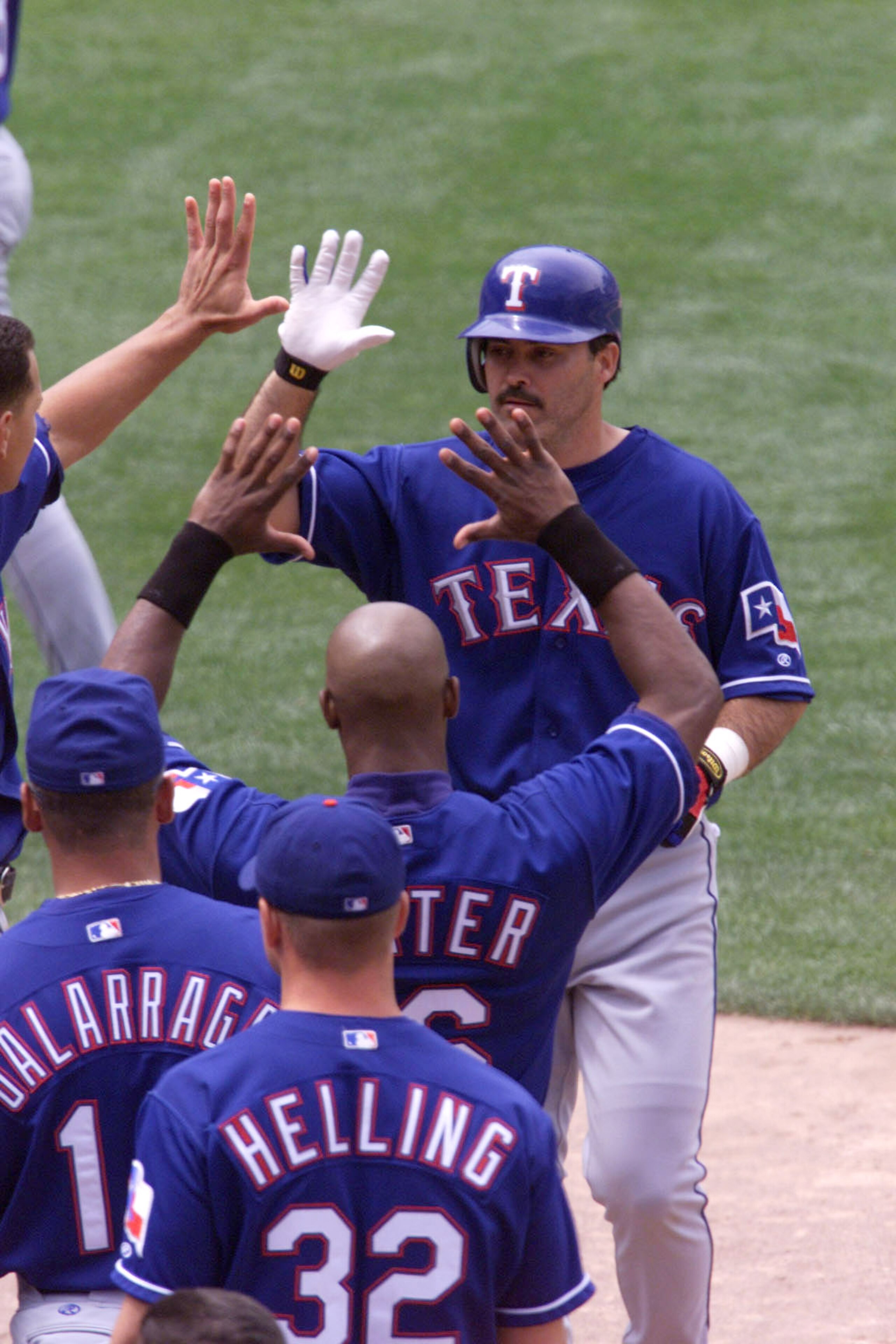 24 JUN 2001: Rafael Palmeiro #25 of theTexas Rangers is congradulated after hitting a home run against the Oakland A's at the Network Associates Coliseum in Oakland, California. DIGITAL IMAGE Mandatory Credit: Tom Hauck/ALLSPORT