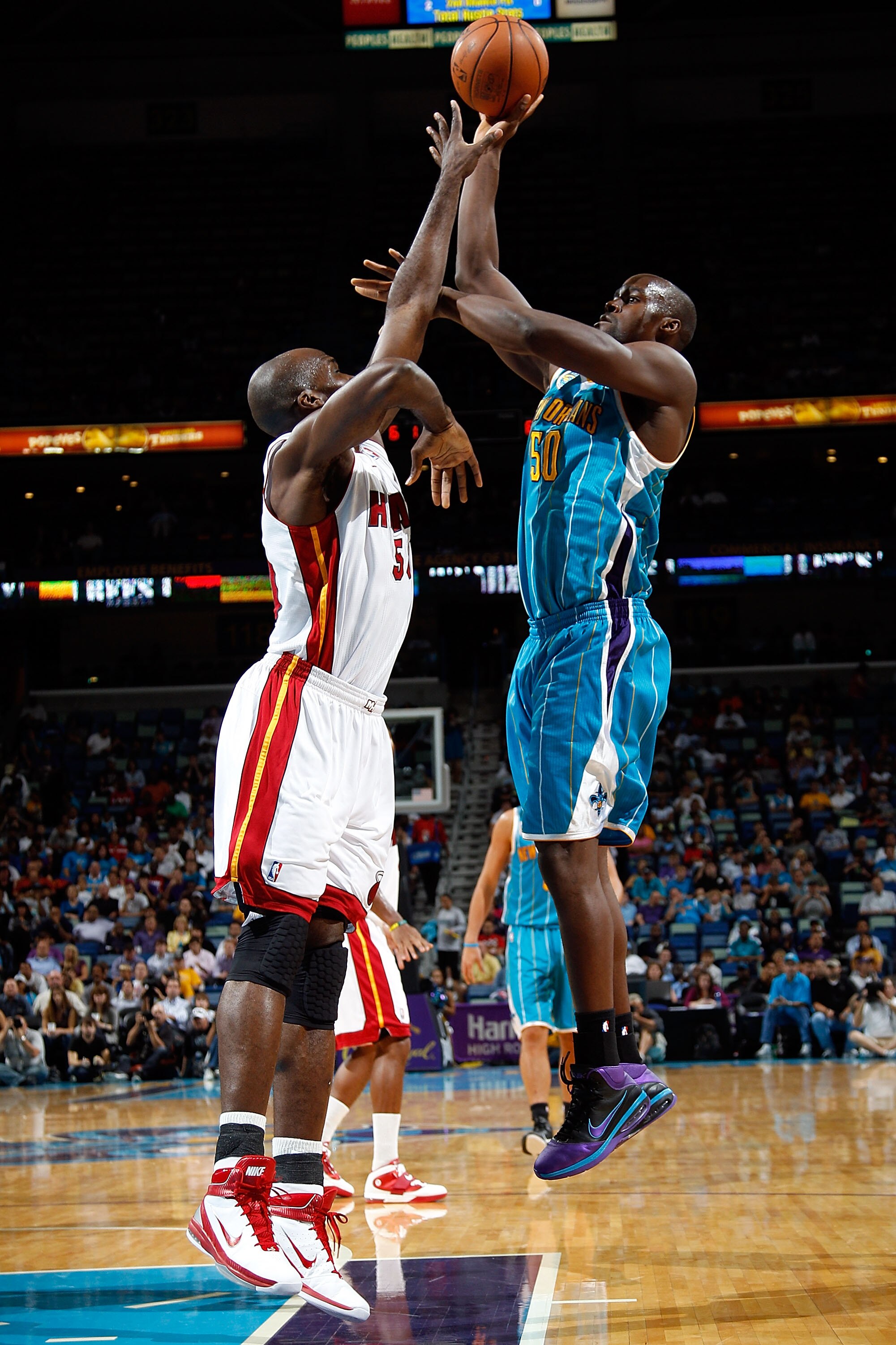 NEW ORLEANS - OCTOBER 13:  Emeka Okafor #50 of the New Orleans Hornets shoots the ball over Joel Anthony #50 of the Miami Heat at the New Orleans Arena on October 13, 2010 in New Orleans, Louisiana. NOTE TO USER: User expressly acknowledges and agrees tha