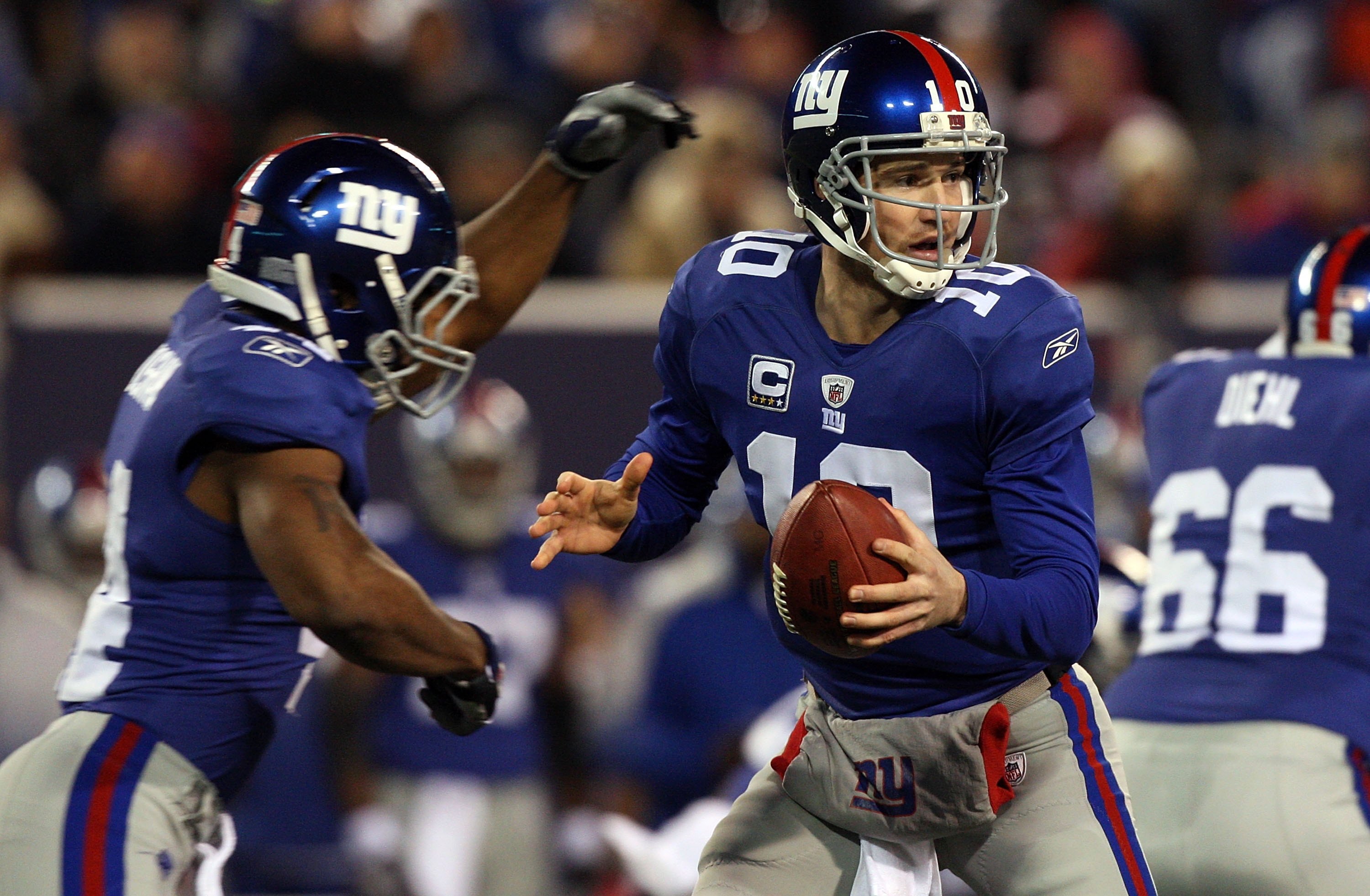 EAST RUTHERFORD, NJ - DECEMBER 06:  Eli Manning #10 of the New York Giants looks to throw a pass against the Dallas Cowboys on December 6, 2009 at Giants Stadium in East Rutherford, New Jersey. The Giants defeated the Cowboys 31-24.  (Photo by Jim McIsaac