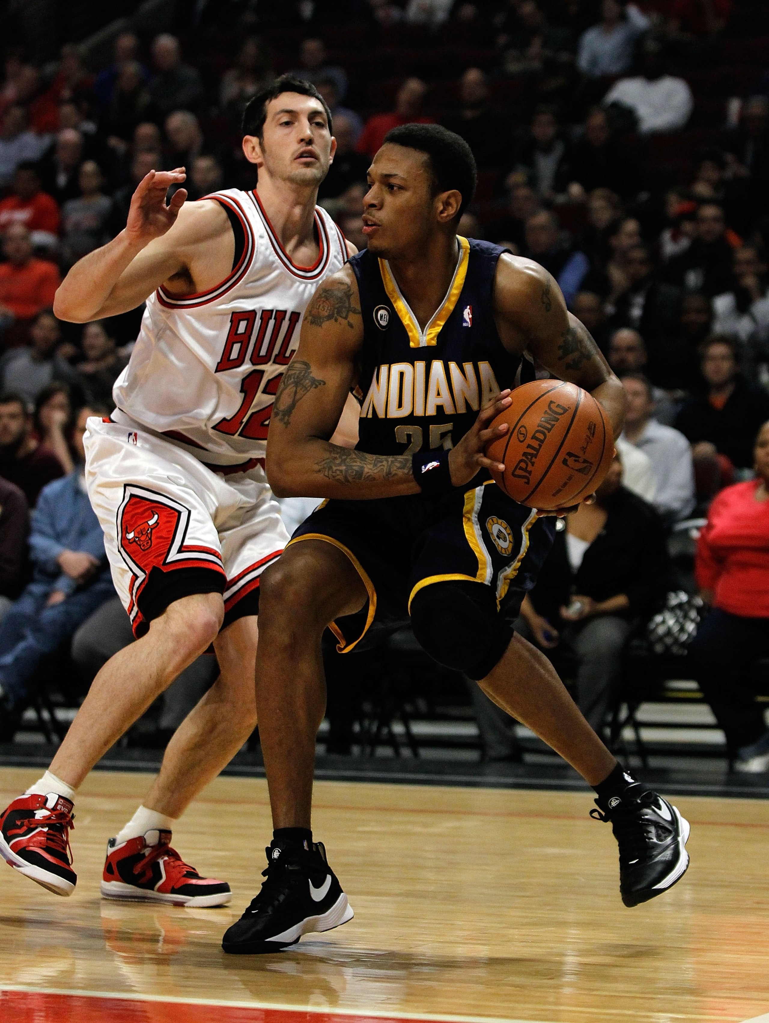 CHICAGO - FEBRUARY 24: Brandon Rush #25 of the Indiana Pacers moves around Kirk Hinrich #12 of the Chicago Bulls at the United Center on February 24, 2010 in Chicago, Illinois. The Bulls defeated the Pacers 120-110. NOTE TO USER: User expressly acknowledg