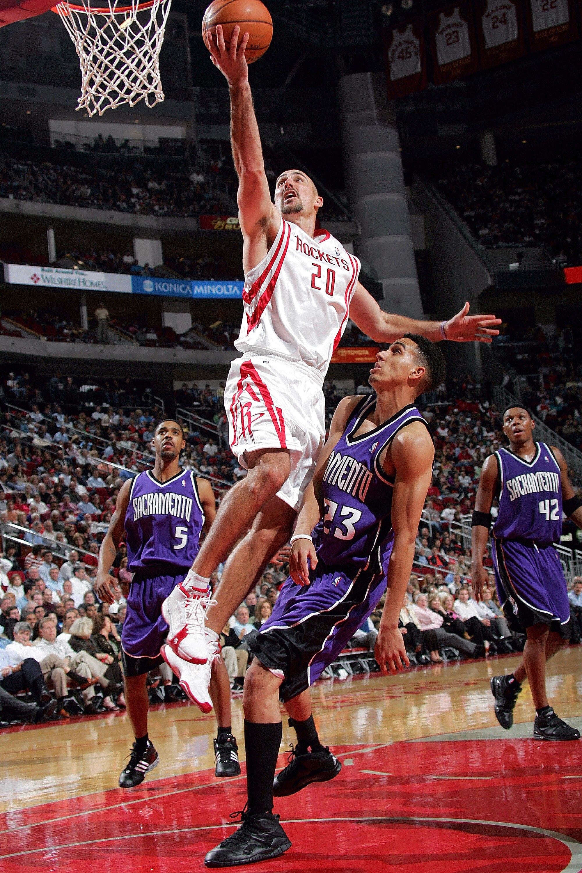 HOUSTON - NOVEMBER 2:  Guard Jon Barry #20 of the Houston Rockets moves the ball past Kevin Martin #23 of the  Sacramento Kings on November 2, 2005 at the Toyota Center in Houston, Texas.  NOTE TO USER:  User expressly acknowledges and agrees that, by dow