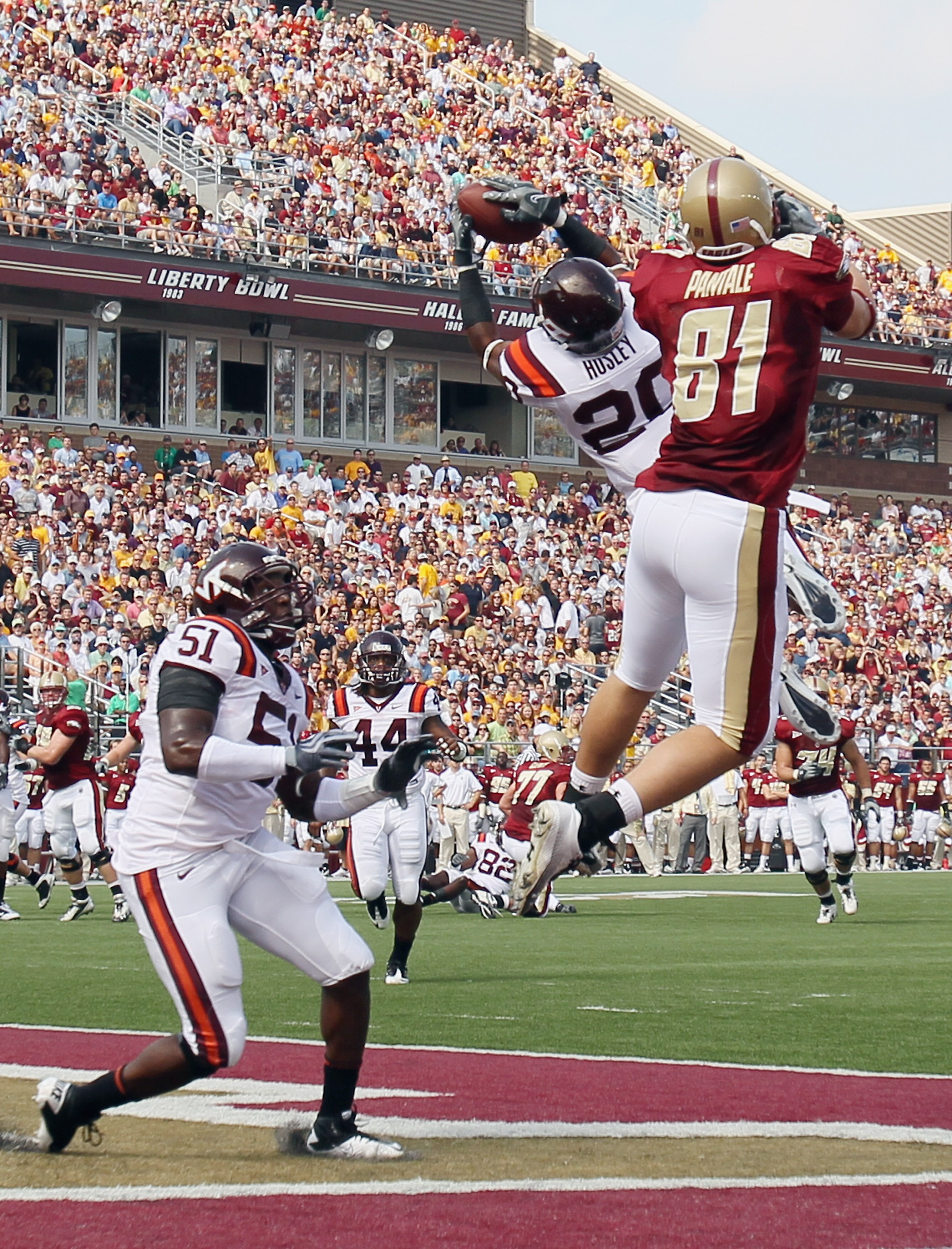CHESTNUT HILL, MA - SEPTEMBER 25:  Jayron Hosley #20 of the Virginia Tech Hokies intercepts a pass intended for Chris Pantale #81 of the Boston College Eagles as Bruce Taylor #51 of Virginia Tech defends on September 25, 2010 at Alumni Stadium in Chestnut