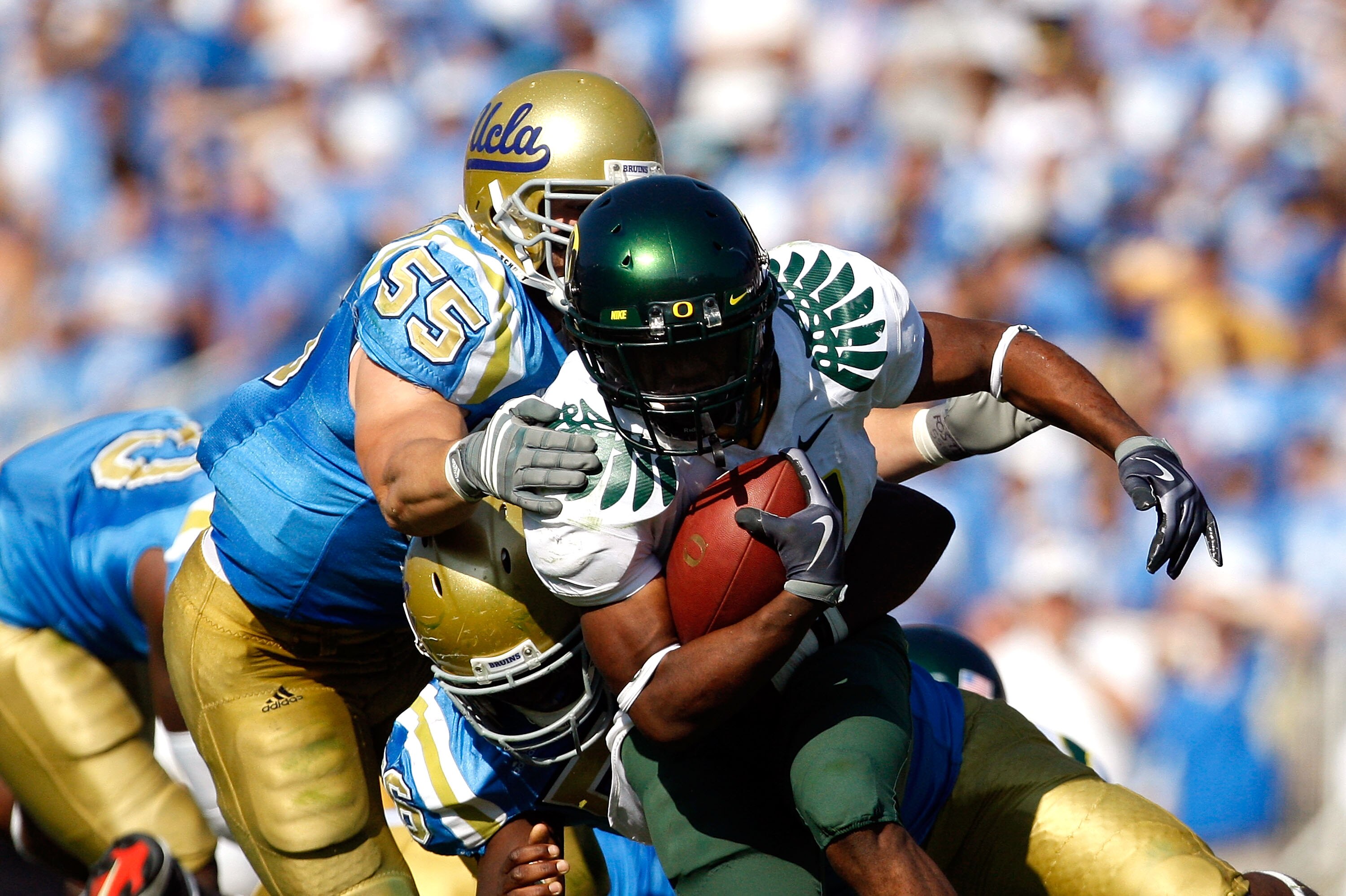 PASADENA, CA. - OCTOBER 10:  Kenjon Barner #24 of the Oregon Ducks runs the ball in the Fourth Quarter as Korey Bosworth #55 tackles him on October 10, 2009 at the Rosebowl in Pasadena, California.  (Photo by Jacob De golish/Getty Images)