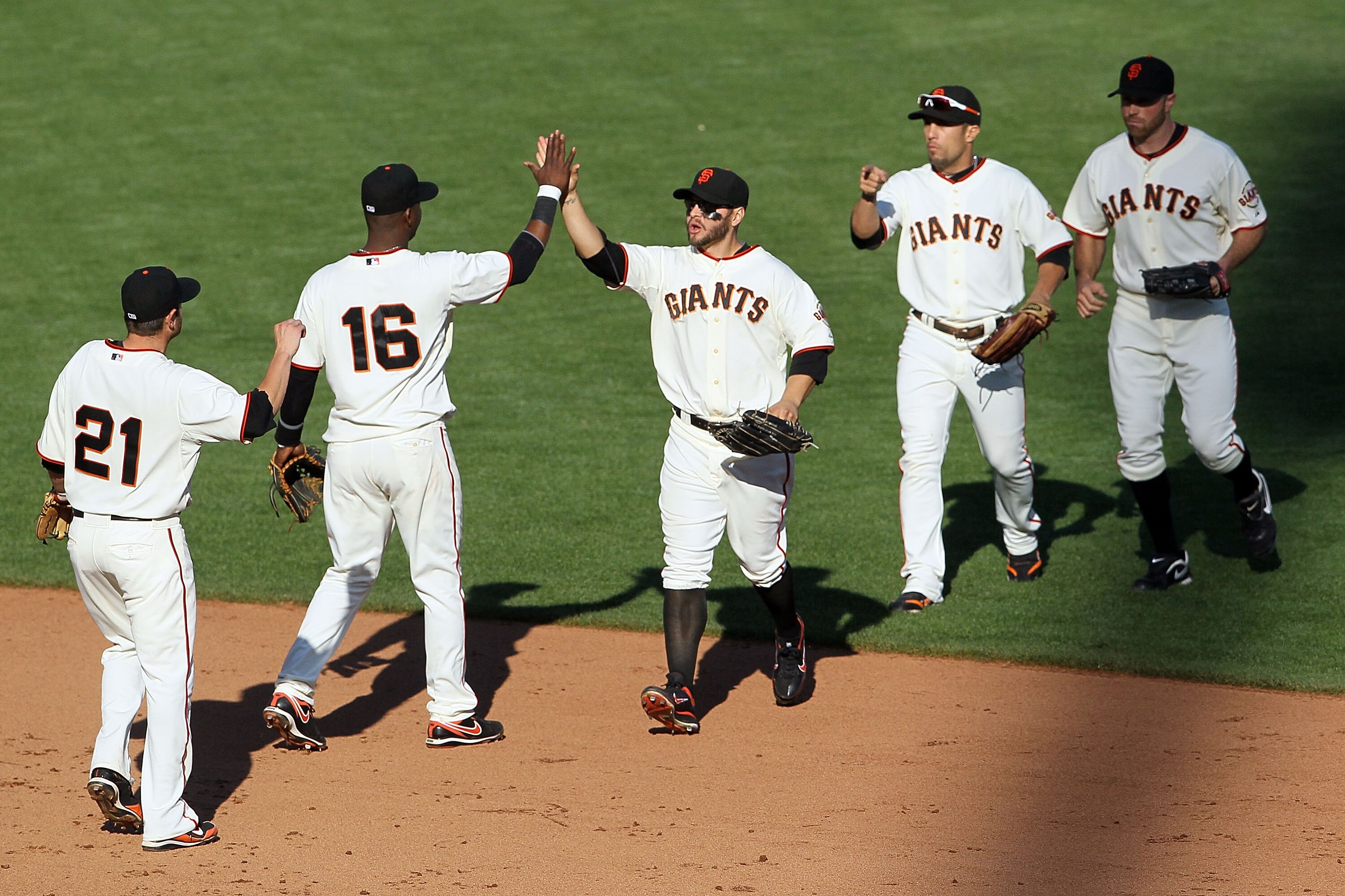 SAN FRANCISCO - OCTOBER 19:  Cody Ross #13 (C) of the San Francisco Giants celebrates with teammates after beating the Philadelphia Phillies 3-0 in Game Three of the NLCS during the 2010 MLB Playoffs at AT&T Park on October 19, 2010 in San Francisco, Cali