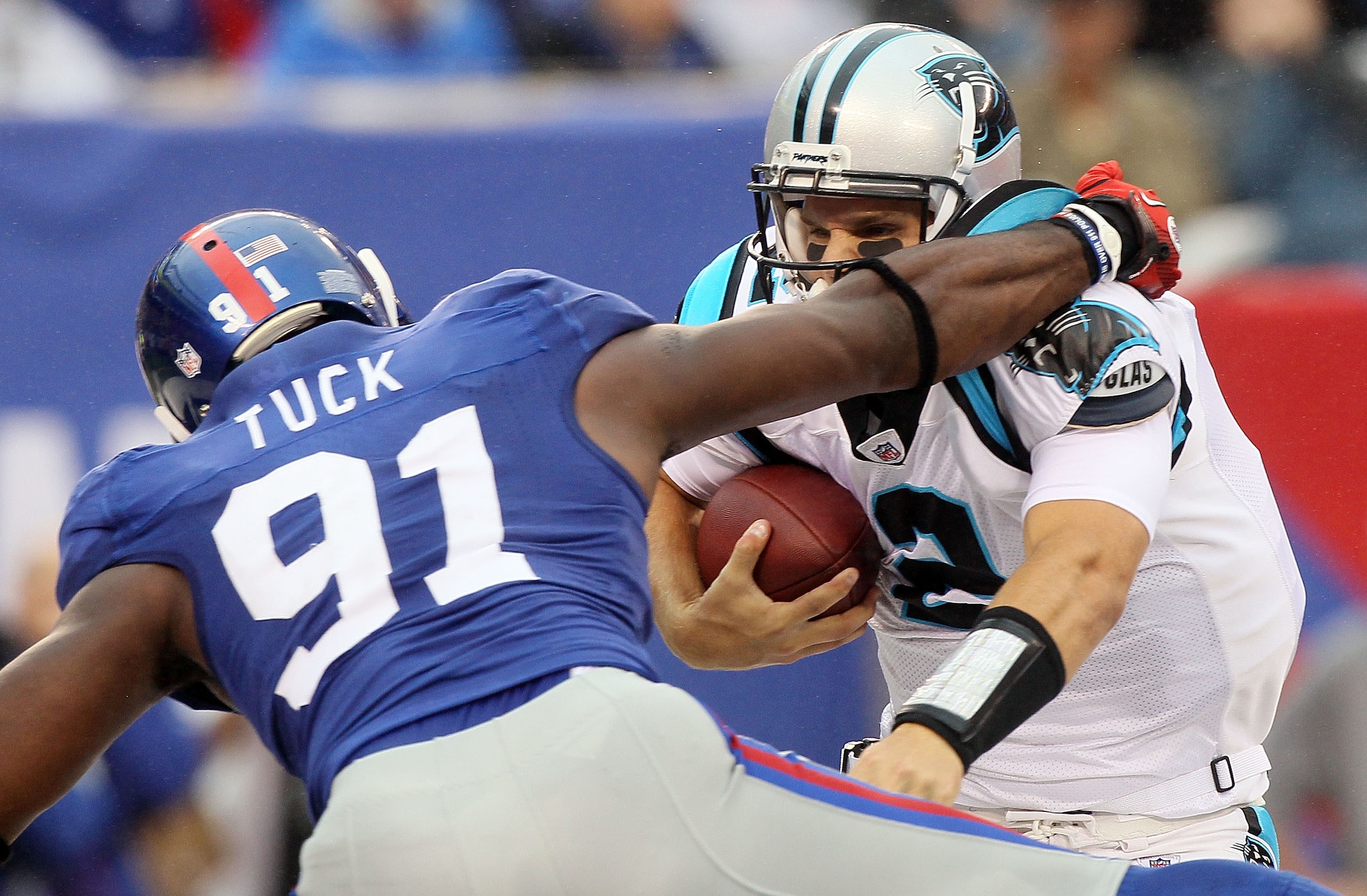 EAST RUTHERFORD, NJ - SEPTEMBER 12:  Jimmy Clausen #2 of the Carolina Panthers tries to avoid a sack attempt from Justin Tuck #91 of the New York Giants on September 12, 2010 at the New Meadowlands Stadium in East Rutherford, New Jersey. The Giants defeat