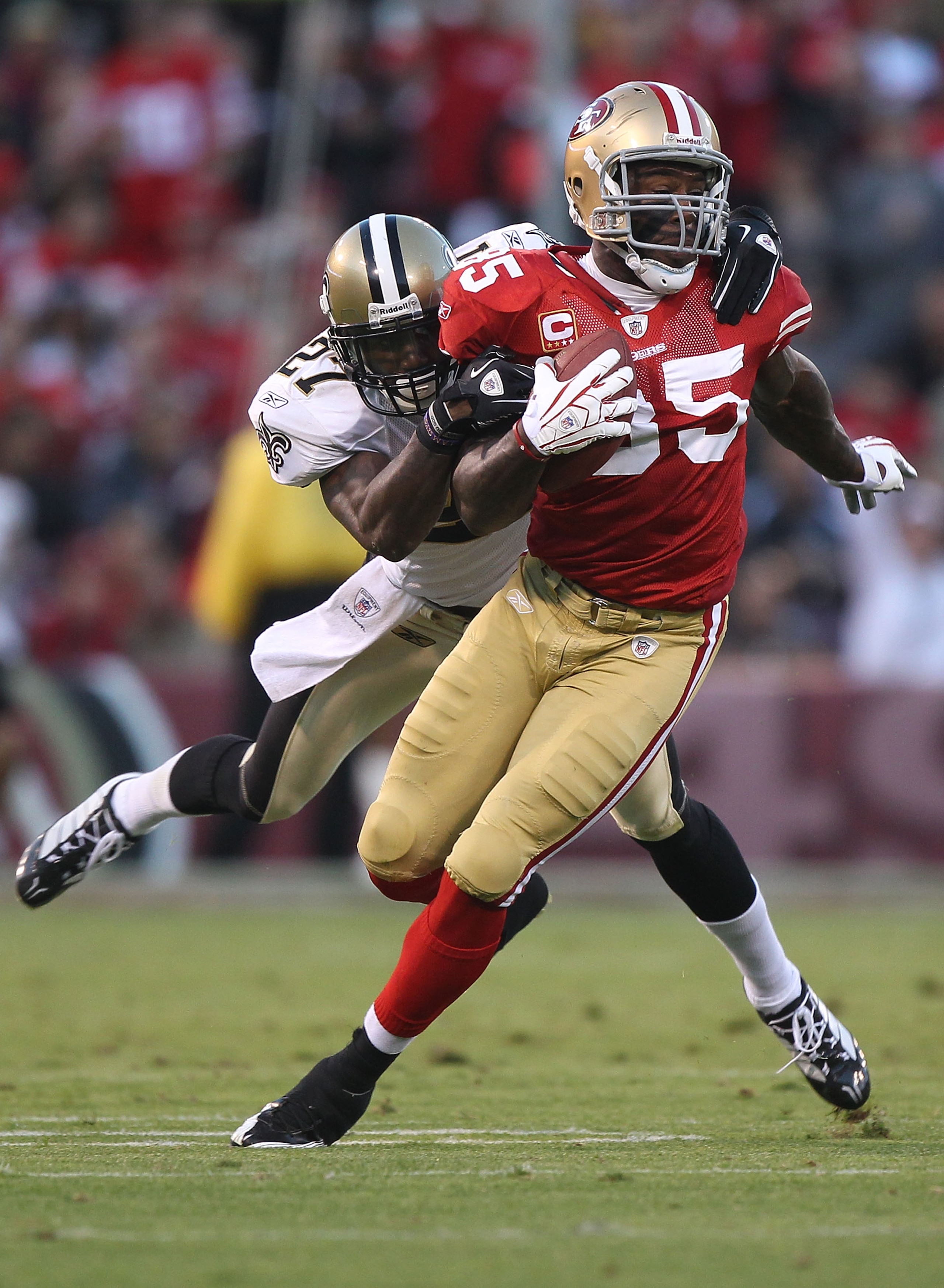 SAN FRANCISCO - SEPTEMBER 20:  Vernon Davis #85 of the San Francisco 49er runs after a catch against Malcolm Jenkins #27 of the New Orleans Saints during an NFL game at Candlestick Park on September 20, 2010 in San Francisco, California.(Photo by Jed Jaco