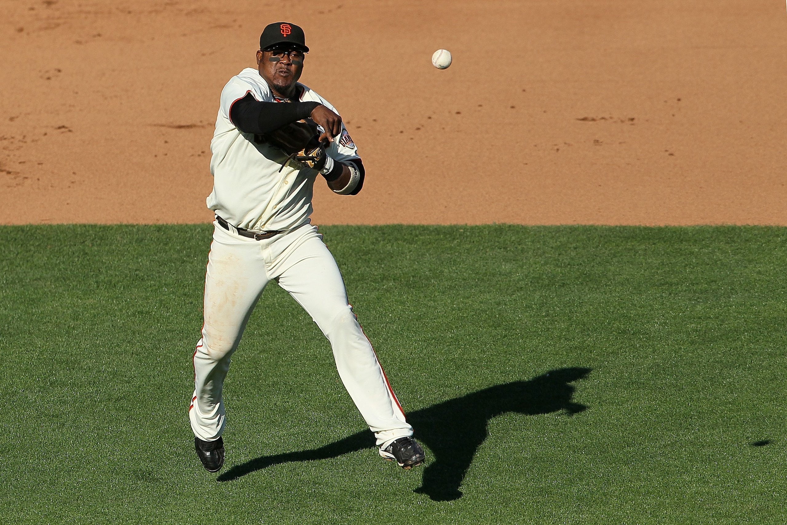 SAN FRANCISCO - OCTOBER 19:  Juan Uribe #5 of the San Francisco Giants throws to first base in the eighth inning of Game Three of the NLCS against the Philadelphia Phillies during the 2010 MLB Playoffs at AT&T Park on October 19, 2010 in San Francisco, Ca