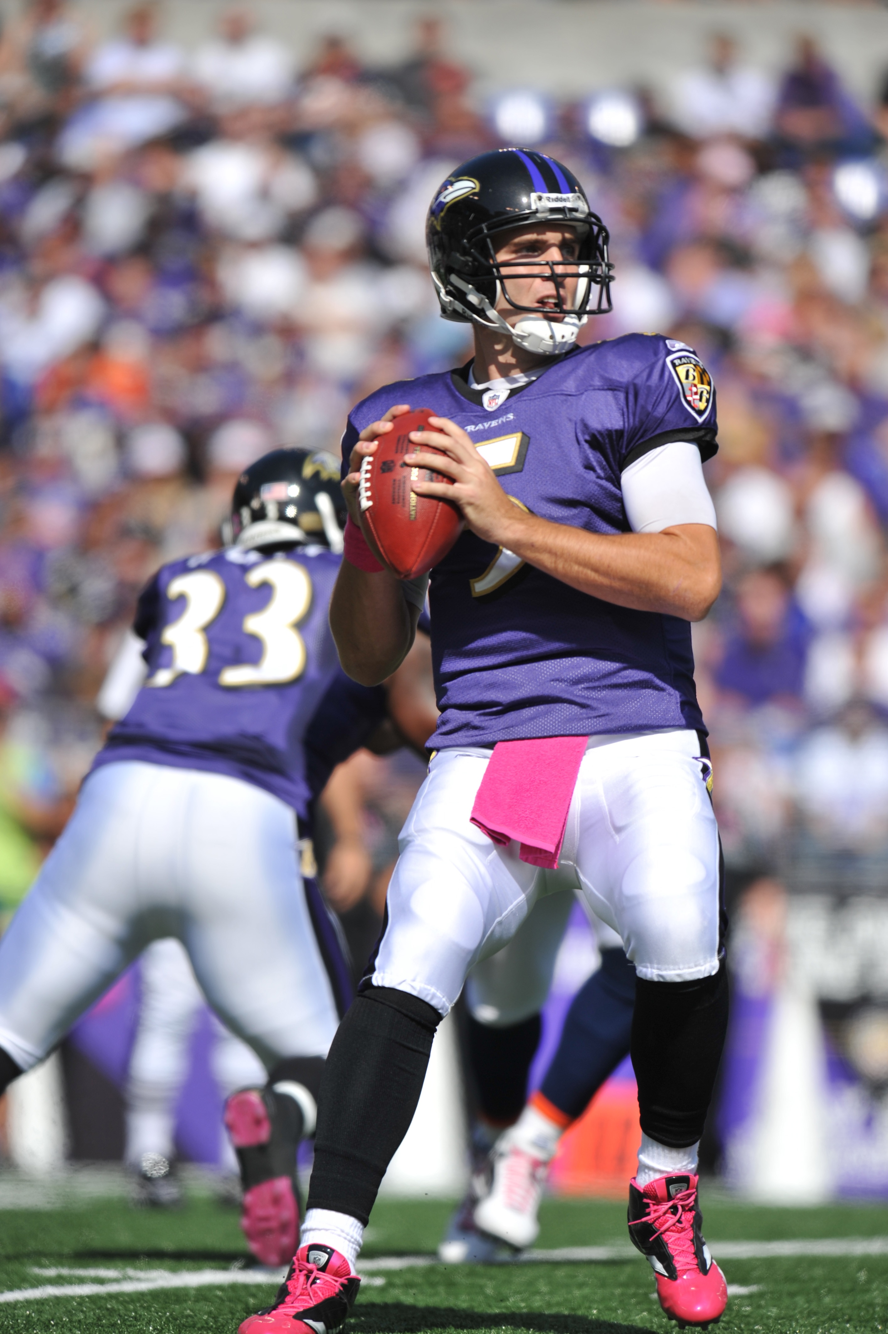 BALTIMORE, MD - OCTOBER 10: Joe Flacco #5 of the Baltimore Ravens looks for a receiver during the game against the Denver Broncos at M&T Bank Stadium on October 10, 2010 in Baltimore, Maryland. Players wore pink in recognition of Breast Cancer Awareness M