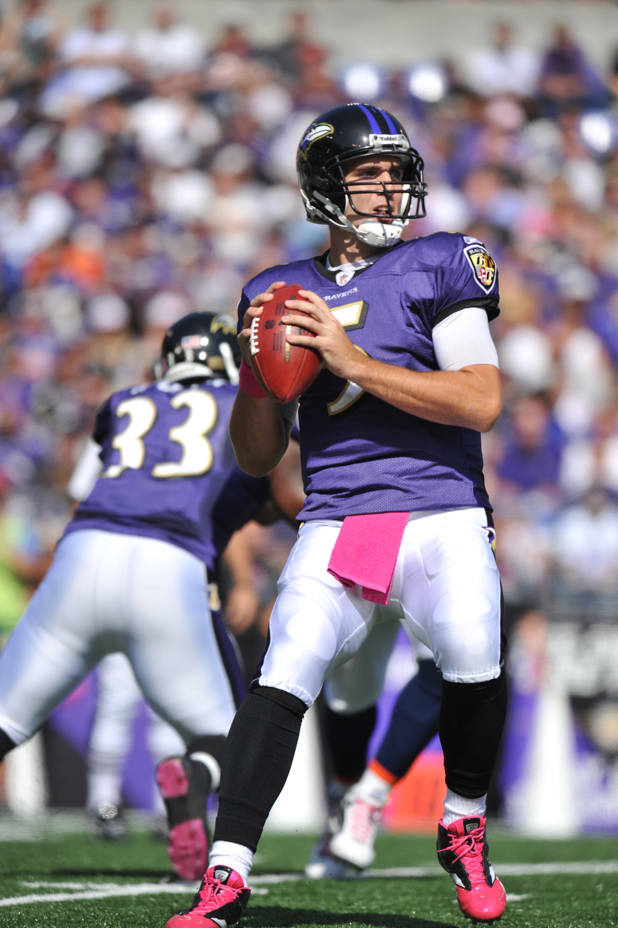 BALTIMORE, MD - OCTOBER 10: Joe Flacco #5 of the Baltimore Ravens looks for a receiver during the game against the Denver Broncos at M&T Bank Stadium on October 10, 2010 in Baltimore, Maryland. Players wore pink in recognition of Breast Cancer Awareness M