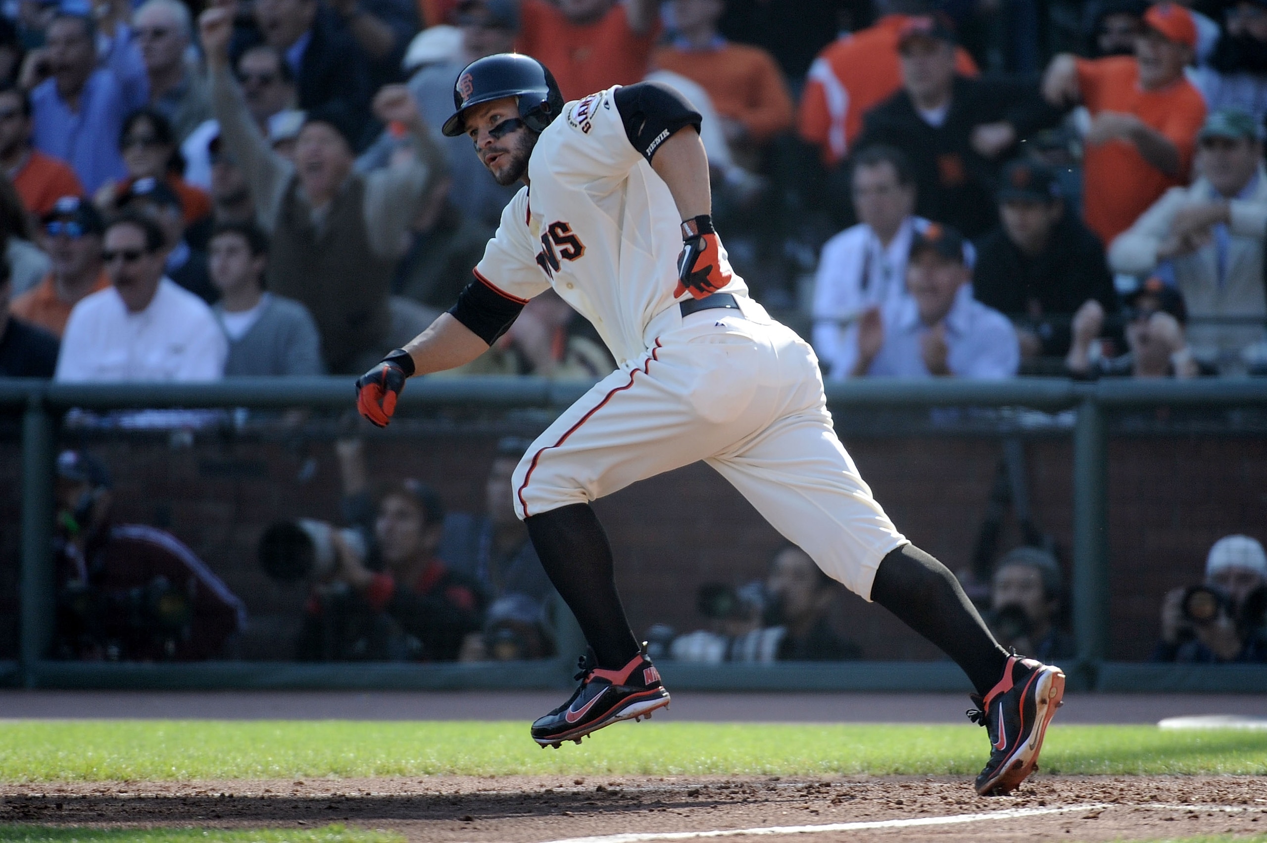 SAN FRANCISCO - OCTOBER 19:  Cody Ross #13 of the San Francisco Giants runs to first after hitting an RBI single against Cole Hamels #35 of the Philadelphia Phillies in the fourth inning of Game Three of the NLCS during the 2010 MLB Playoffs at AT&T Park 