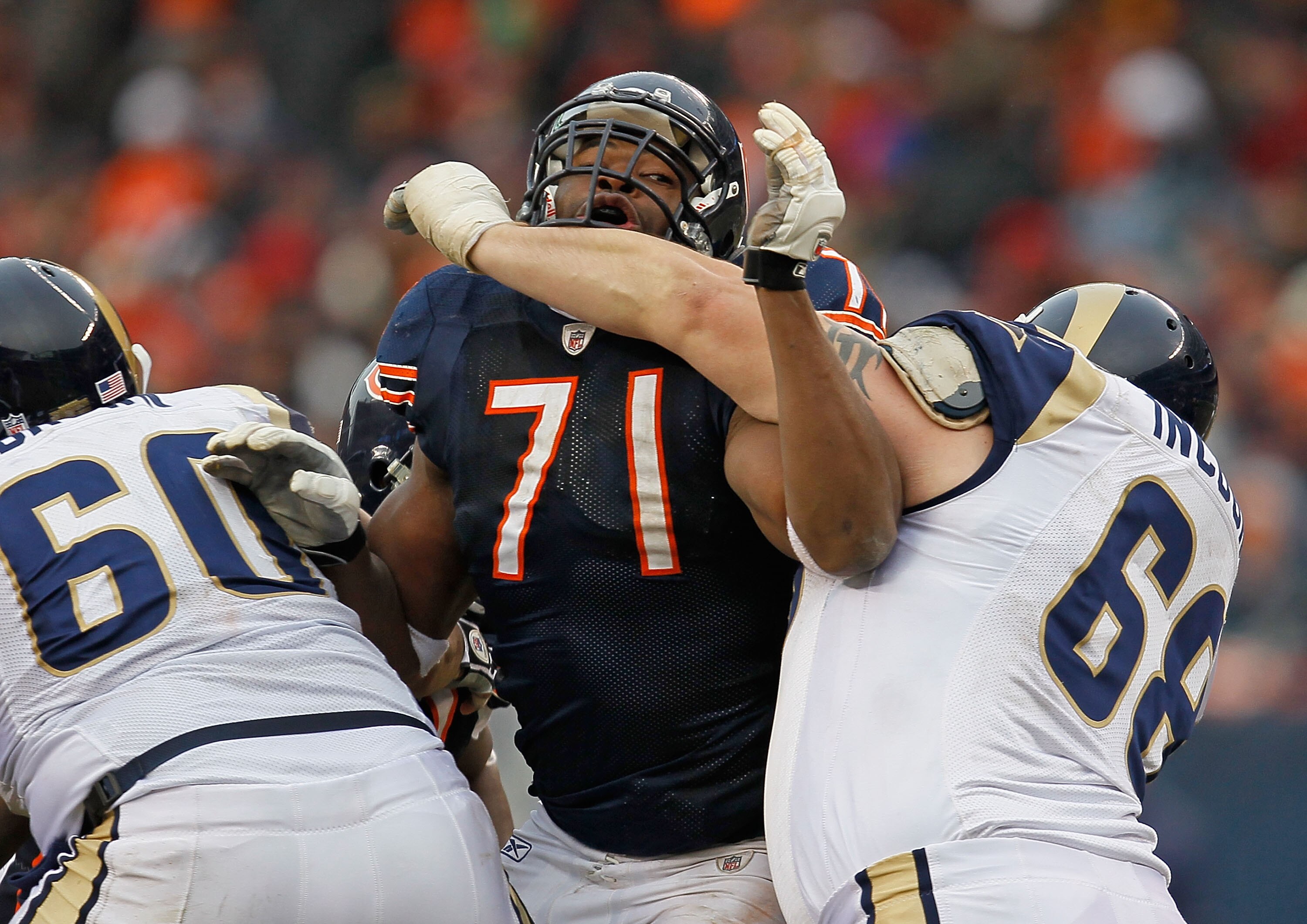 CHICAGO - DECEMBER 06: Israel Odonije #71 of the Chicago Bears rushes against Jason Brown #60 and Richie Incognito #68 of the St. Louis Rams at Soldier Field on December 6, 2009 in Chicago, Illinois. The Bears defeated the Rams 17-9. (Photo by Jonathan Da