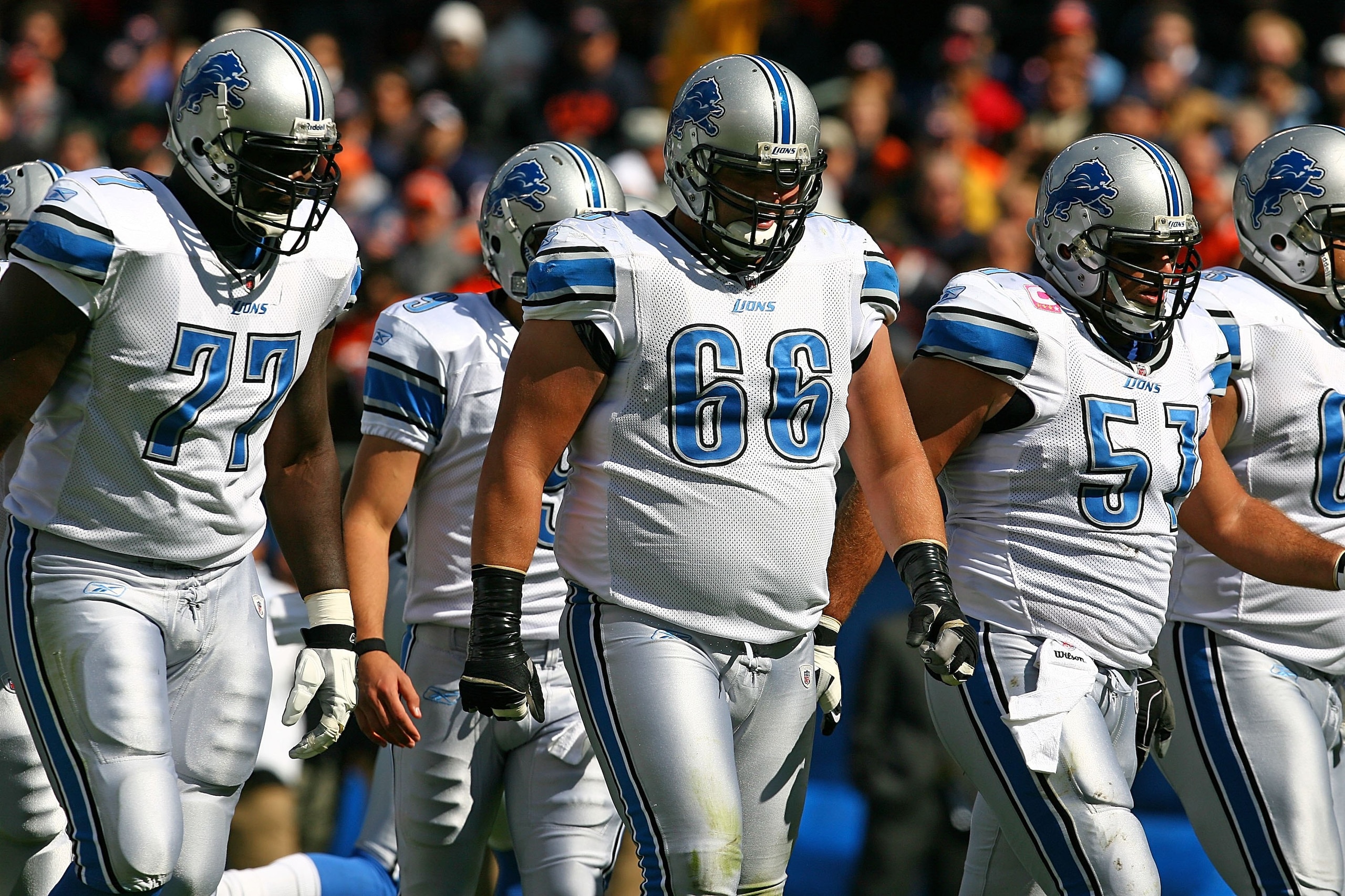 CHICAGO - OCTOBER 04: Gosder Cherilus #77, Stephen Peterman #66 and Dominic Raiola #51 of the Detroit Lions line-up for an offensive play against the Chicago Bears on October 4, 2009 at Soldier Field in Chicago, Illinois. The Bears defeated the Lions 48-2