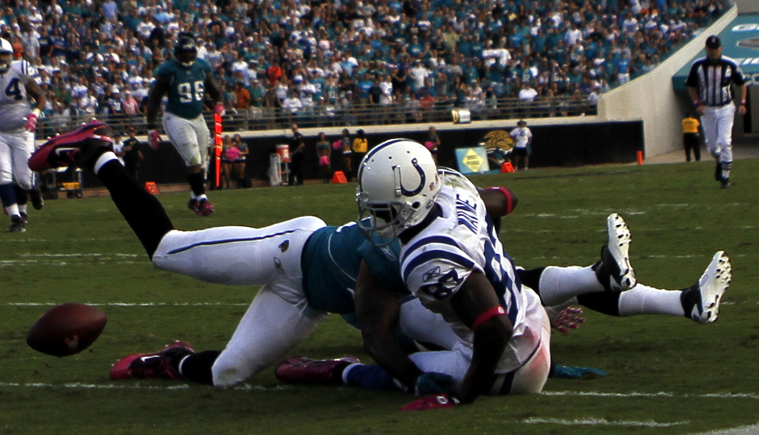 JACKSONVILLE, FL - OCTOBER 03:  Receiver Reggie Wayne #87 of the Indianapolis Colts fumbles against the Jacksonville Jaguars at EverBank Field on October 3, 2010 in Jacksonville, Florida. The Jaguars won 31-28.  (Photo by Marc Serota/Getty Images)