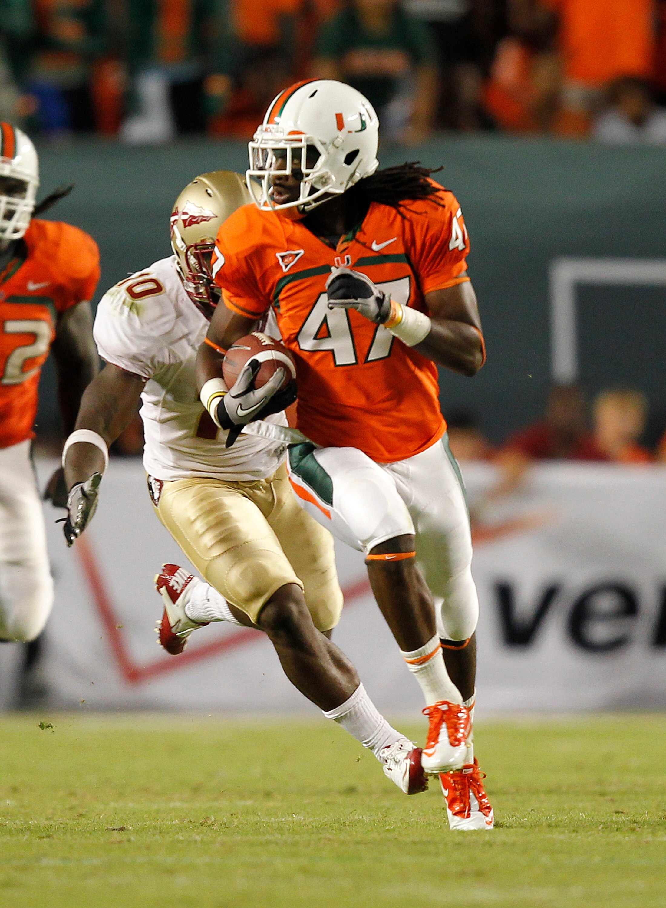 MIAMI, FL - OCTOBER 9: LaRon Byrd #47 of the Miami Hurricanes runs with the ball while being chased by Nick Moody #10 of the Florida State Seminoles on October 9, 2010 at Sun Life Stadium in Miami, Florida. The Seminoles defeated the Hurricanes 45-17. (Ph