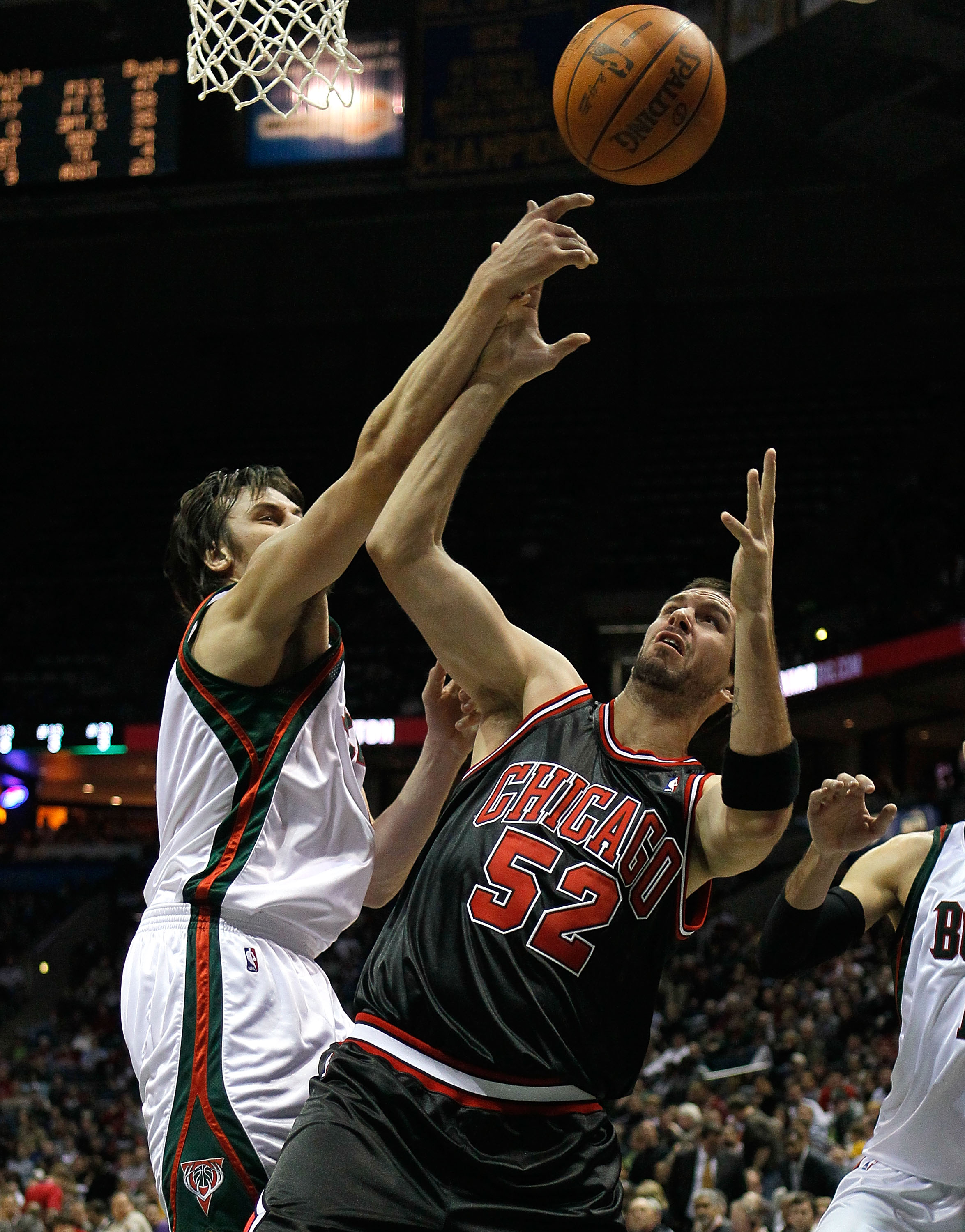 MILWAUKEE - NOVEMBER 30: Brad Miller #52 of the Chicago Bulls battles for a rebound with Andrew Bogut #6 of the Milwaukee Bucks at the Bradley Center on November 30, 2009 in Milwaukee, Wisconsin. The Bucks defeated the Bulls 99-97. NOTE TO USER: User expr