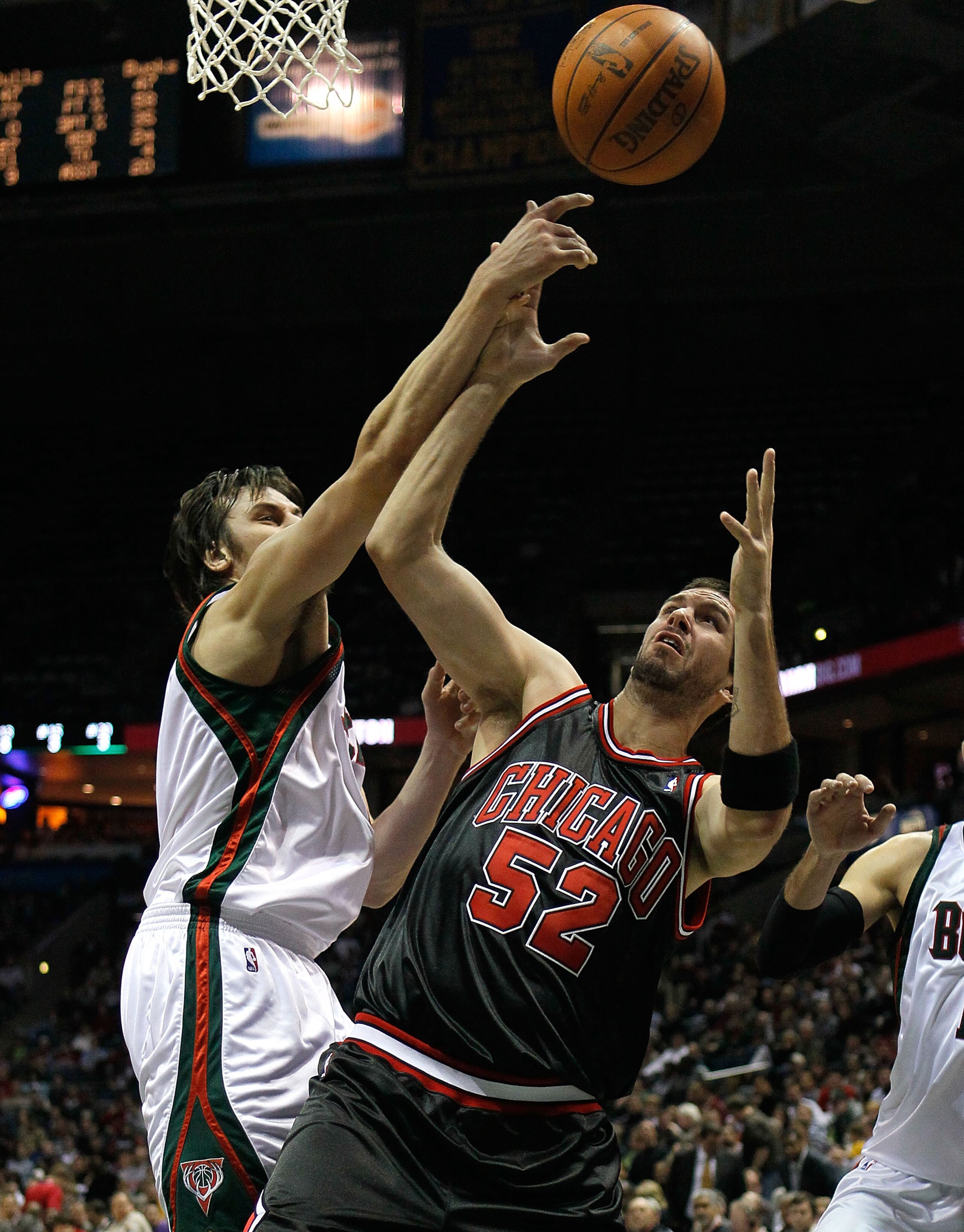 MILWAUKEE - NOVEMBER 30: Brad Miller #52 of the Chicago Bulls battles for a rebound with Andrew Bogut #6 of the Milwaukee Bucks at the Bradley Center on November 30, 2009 in Milwaukee, Wisconsin. The Bucks defeated the Bulls 99-97. NOTE TO USER: User expr