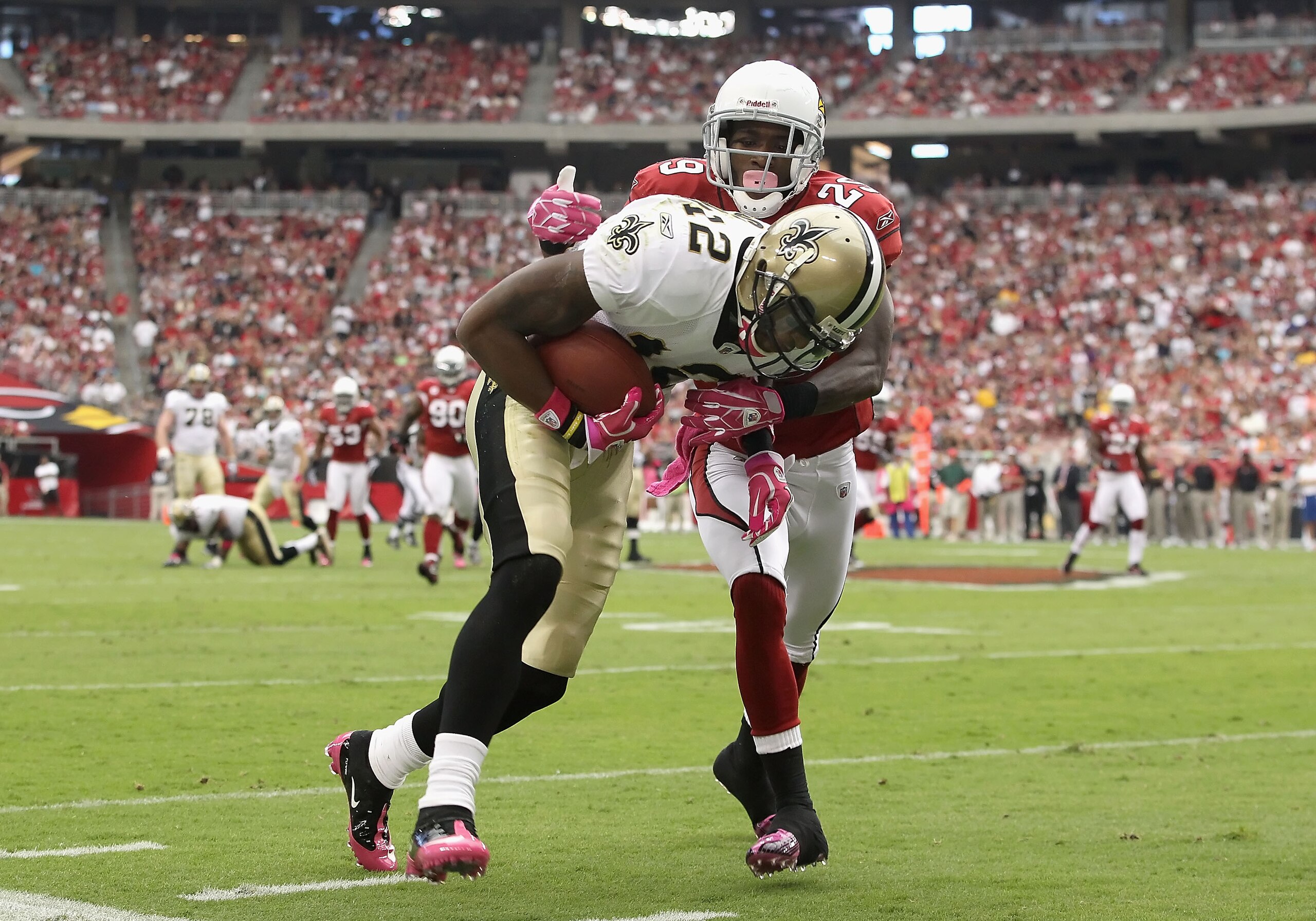 GLENDALE, AZ - OCTOBER 10:  Wide receiver Marques Colston #12 of the New Orleans Saints is tackled by Dominique Rodgers-Cromartie #29 of the Arizona Cardinals after a reception during the first quarter of the NFL game at the University of Phoenix Stadium