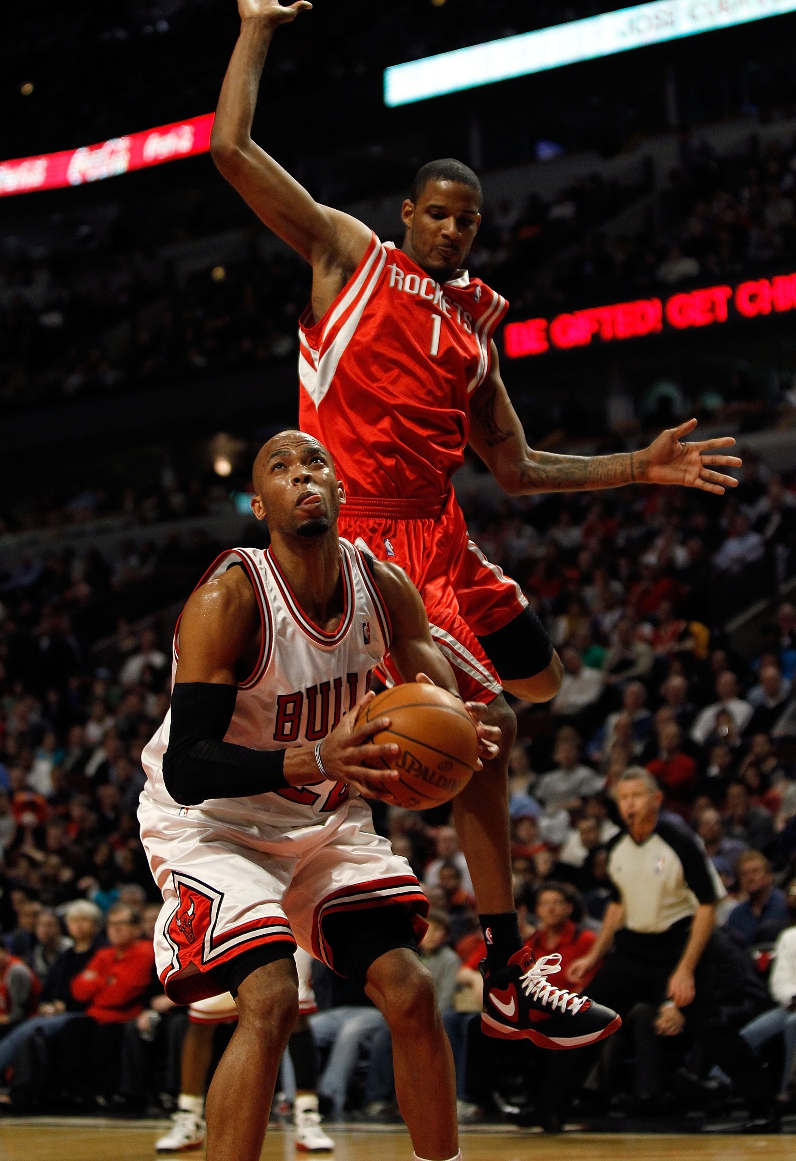 CHICAGO - MARCH 22: Taj Gibson #22 of the Chicago Bulls tries to shoot as Trevor Ariza #1 of the Houston Rockets leaps behind him at the United Center on March 22, 2010 in Chicago, Illinois. The Bulls defeated the Rockets 98-88. NOTE TO USER: User express