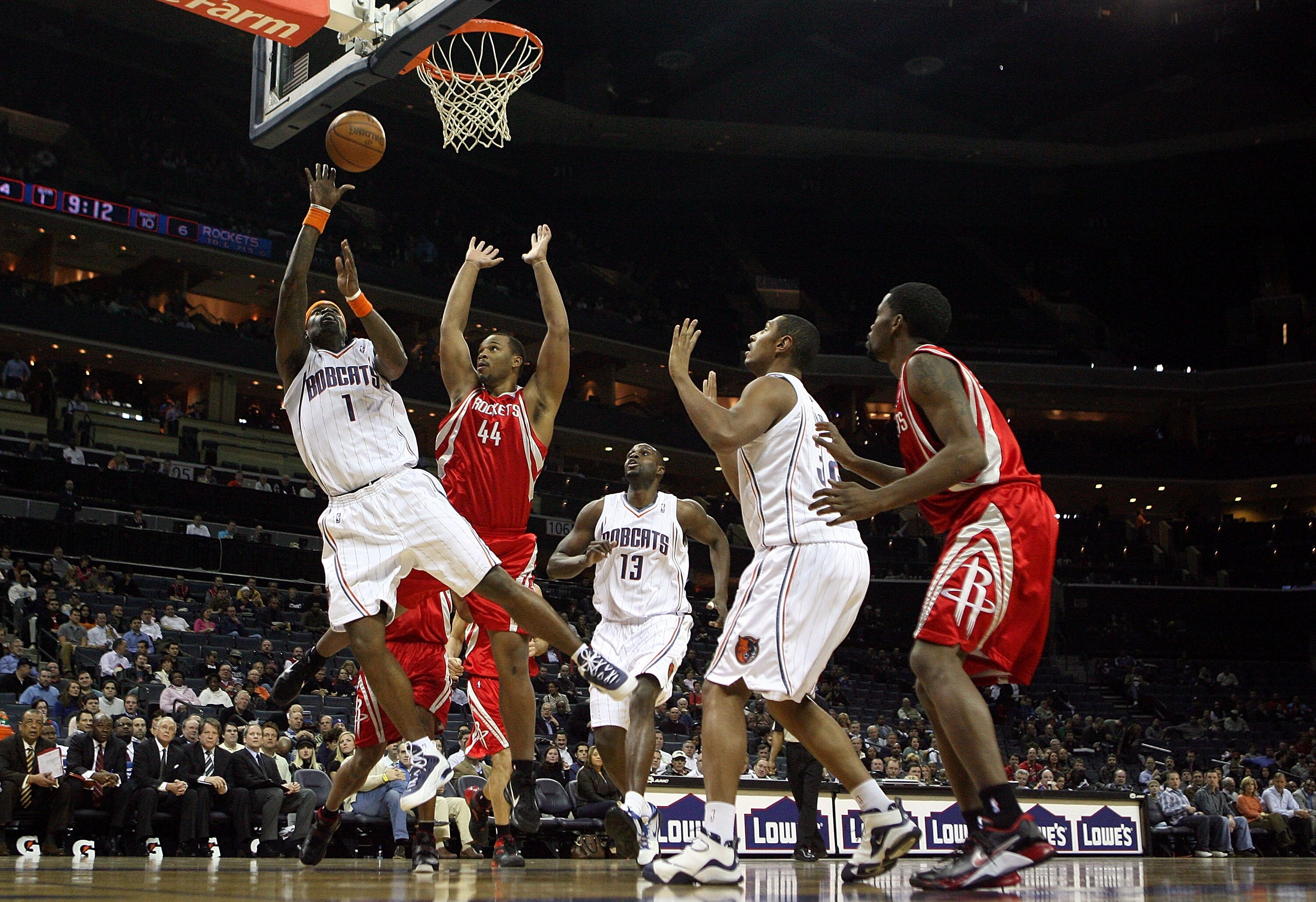 CHARLOTTE, NC - JANUARY 12:  Chuck Hayes #44 of the Houston Rockets watches as Stephen Jackson #1 of the Charlotte Bobcats goes to the basket at Time Warner Cable Arena on January 12, 2010 in Charlotte, North Carolina.  NOTE TO USER: User expressly acknow