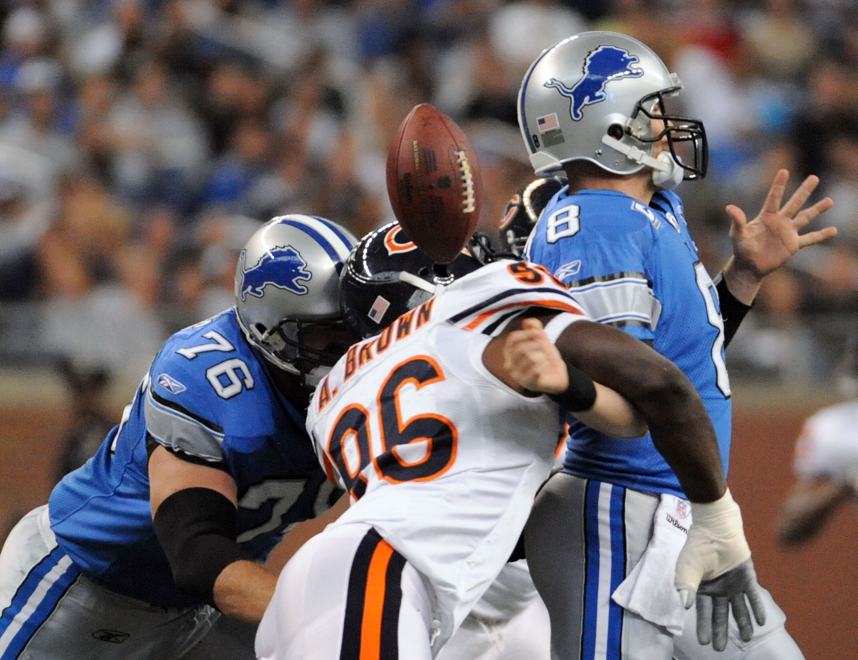 DETROIT - OCTOBER 05:  Alex Brown #96 of the Chicago Bears causes a fumble on a sack of Jon Kitna #8 of the Detroit Lions while defended by Jeff Backus #76 during the first quarter at Ford Field on October 5, 2008 in Detroit, Michigan.  The Bears won 34-7