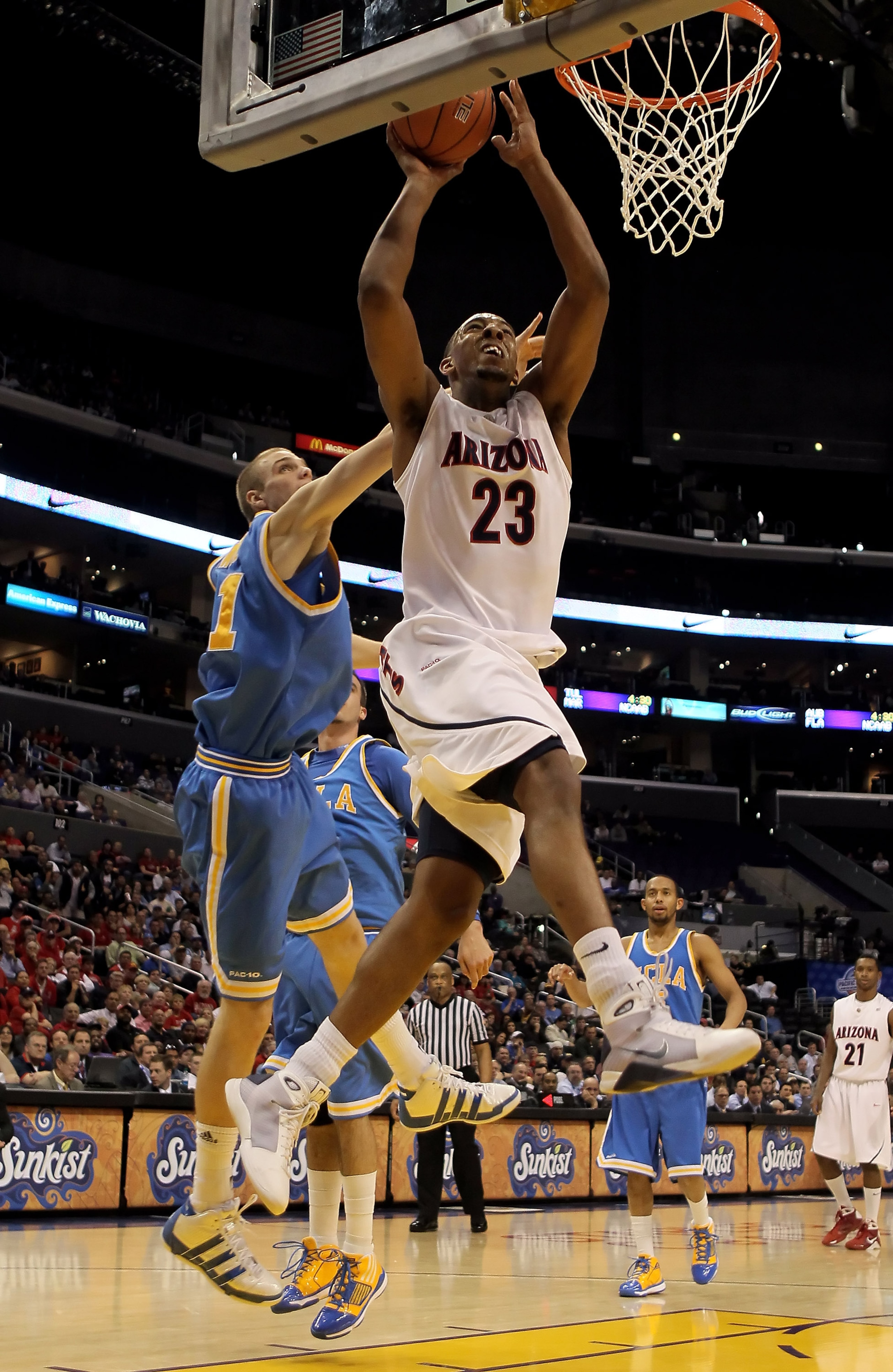 LOS ANGELES, CA - MARCH 11: Derrick Williams #23 of the Arizona Wildcats drives to the basket past Brendan Lane #21 of the UCLA Bruins in the second half during the Quarterfinals of the Pac-10 Basketball Tournament at Staples Center on March 11, 2010 in LOS ANGELES, CA - MARCH 11: Derrick Williams #23 of the Arizona Wildcats drives to the basket past Brendan Lane #21 of the UCLA Bruins in the second half during the Quarterfinals of the Pac-10 Basketball Tournament at Staples Center on March 11, 2010 in