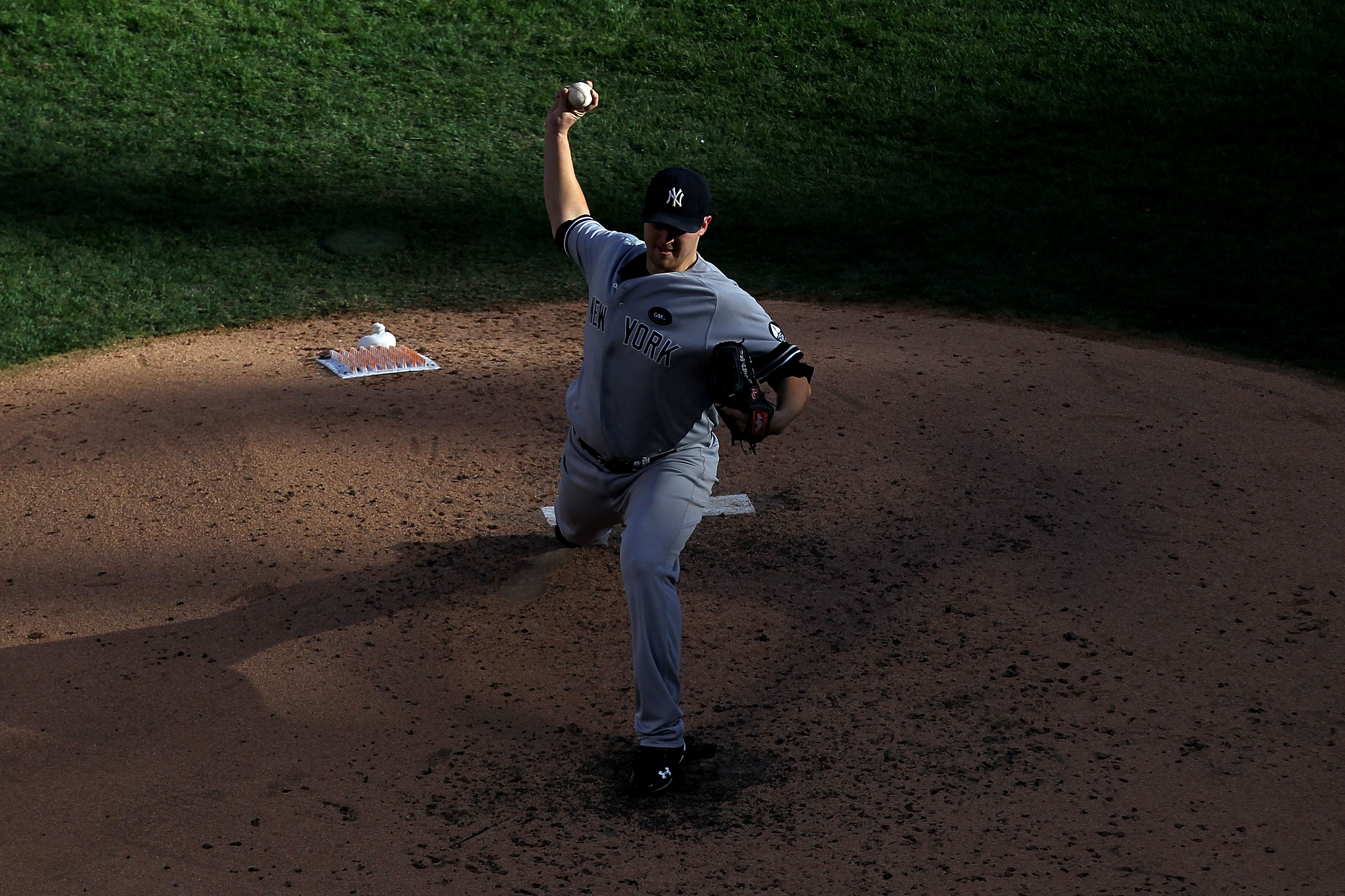 ARLINGTON, TX - OCTOBER 16:  Phil Hughes #65 of the New York Yankees throws a pitch against the Texas Rangers in Game Two of the ALCS during the 2010 MLB Playoffs at Rangers Ballpark in Arlington on October 16, 2010 in Arlington, Texas.  (Photo by Ronald