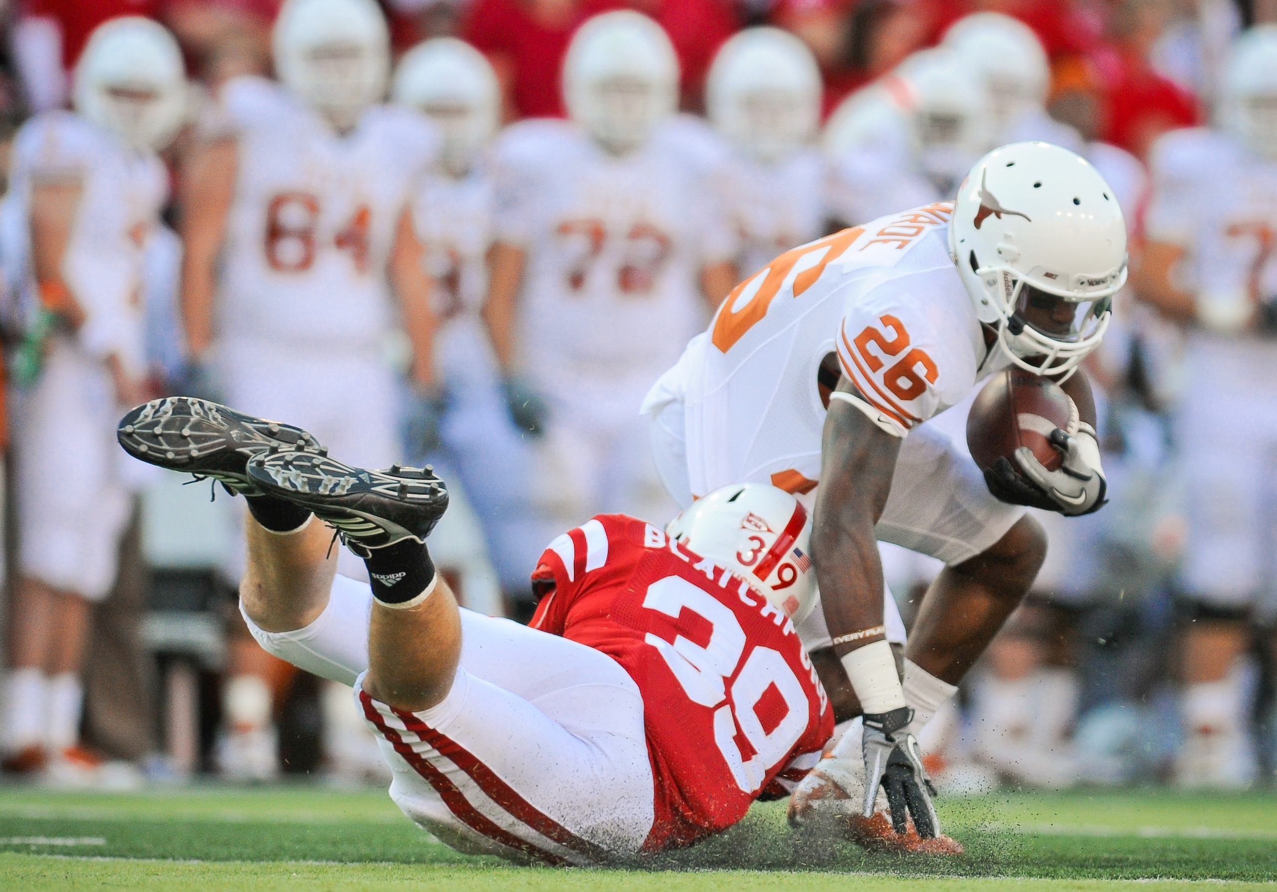 LINCOLN, NE - OCTOBER 16: Running back D.J. Monroe #26 of the Texas Longhorns gets brought down my defensive back Justin Blatchford #39 of the Nebraska Cornhuskers during their game at Memorial Stadium on October 16, 2010 in Lincoln, Nebraska. Texas Defea