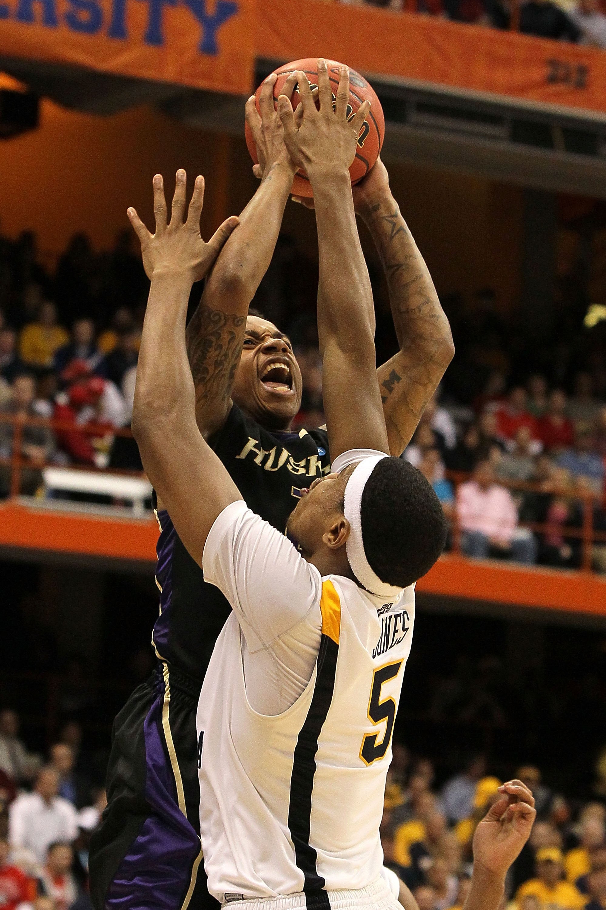 SYRACUSE, NY - MARCH 25:  Isaiah Thomas #2 of the Washington Huskies attempts a shot against Kevin Jones #5 of the West Virginia Mountaineers during the east regional semifinal of the 2010 NCAA men's basketball tournament at the Carrier Dome on March 25,
