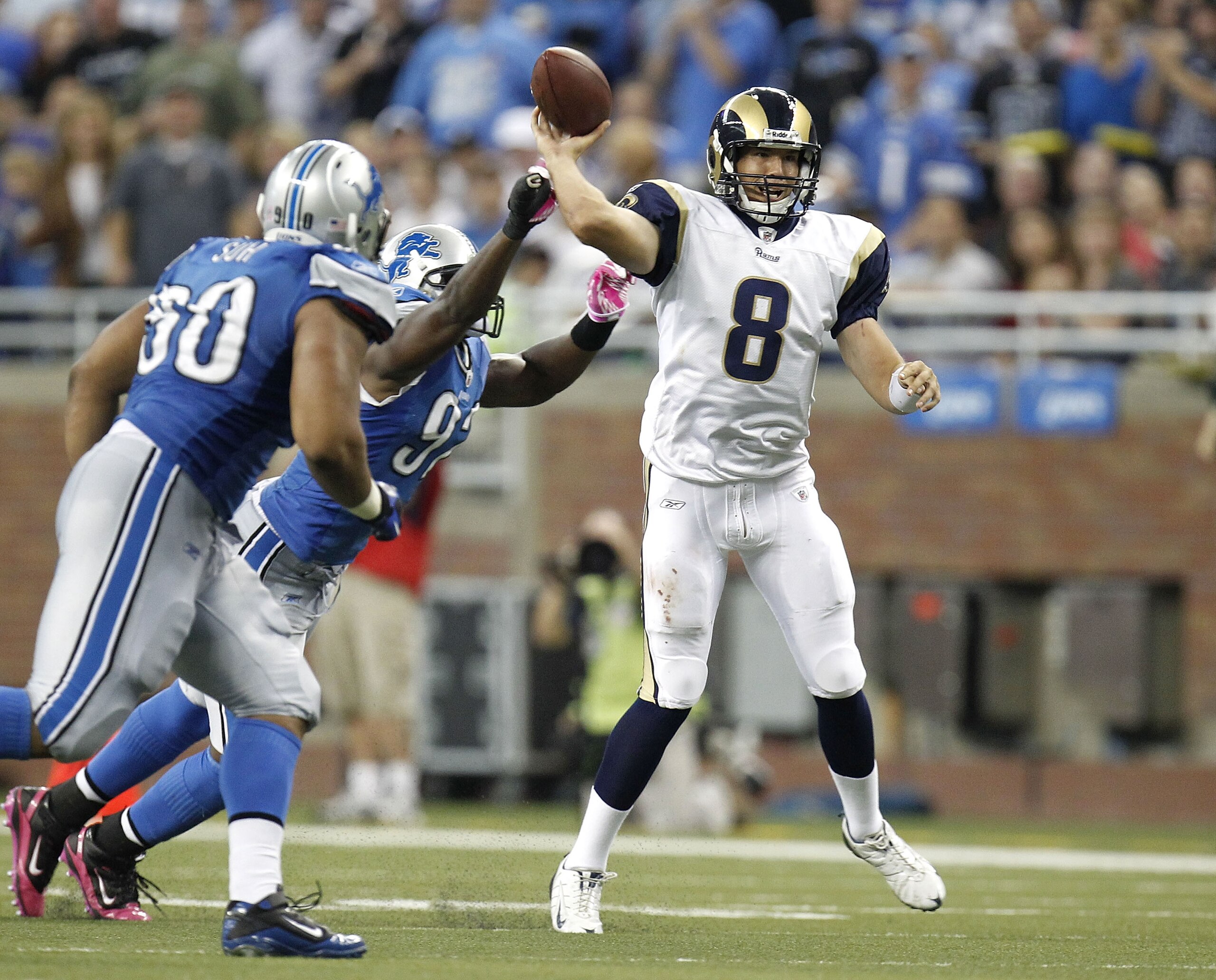 DETROIT - OCTOBER 10: Sam Bradford #8 of the St. Louis Rams tries to get a pass of before being tackled by Cliff Avril #92 and Ndamukong Suh #90 of the Detroit Lions on October 10, 2010 at Ford Field in Detroit, Michigan. Detroit won the game 44-6. (Photo