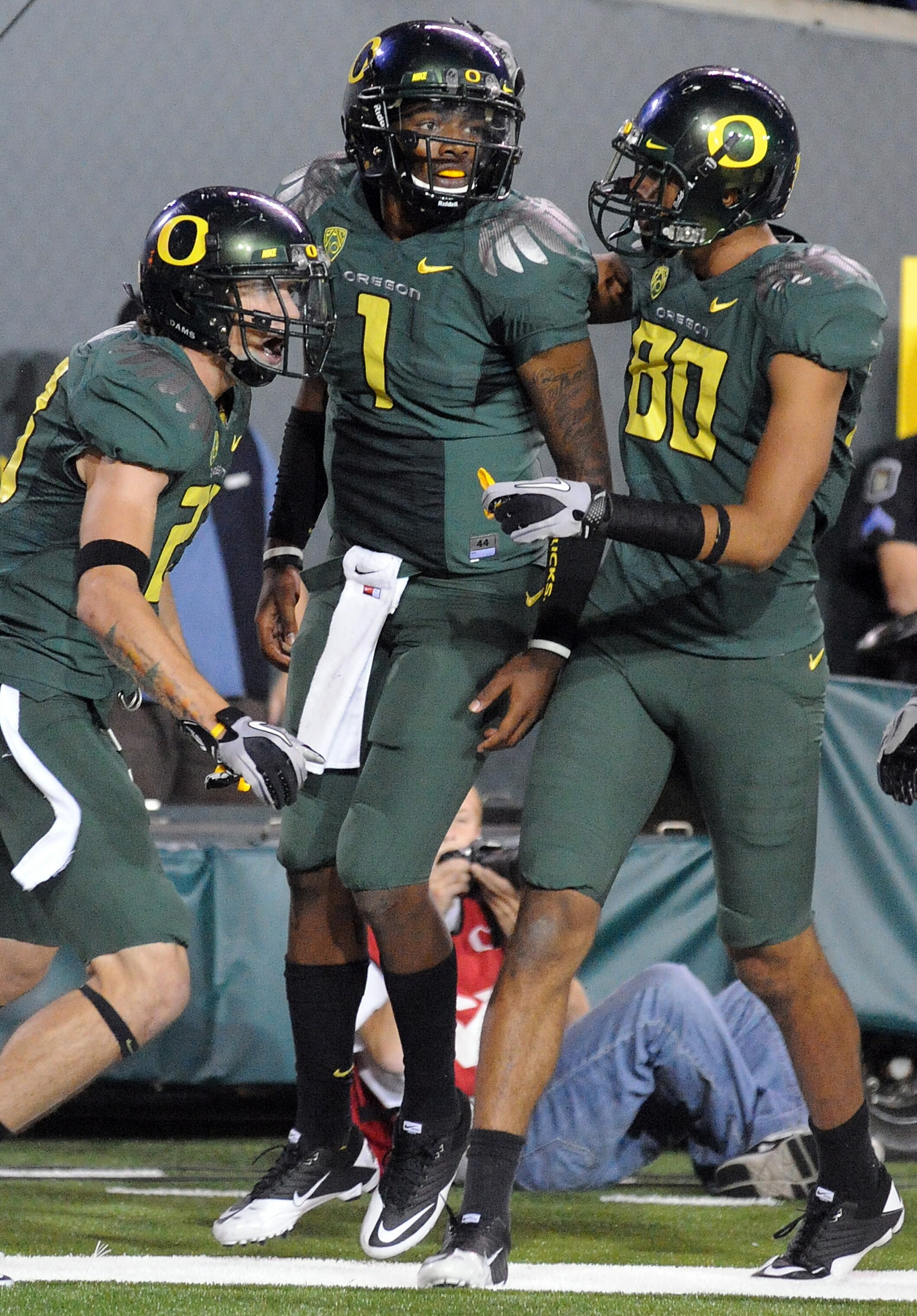 EUGENE, OR - OCTOBER 2: Wide receiver Jeff Maehl #23, quarterback Darron Thomas #1 and wide receiver Lavasier Tuinei #80 of the Oregon Ducks celebrate after Thomas scored a touchdown in the third quarter of the game against the Stanford Cardinal at Autzen