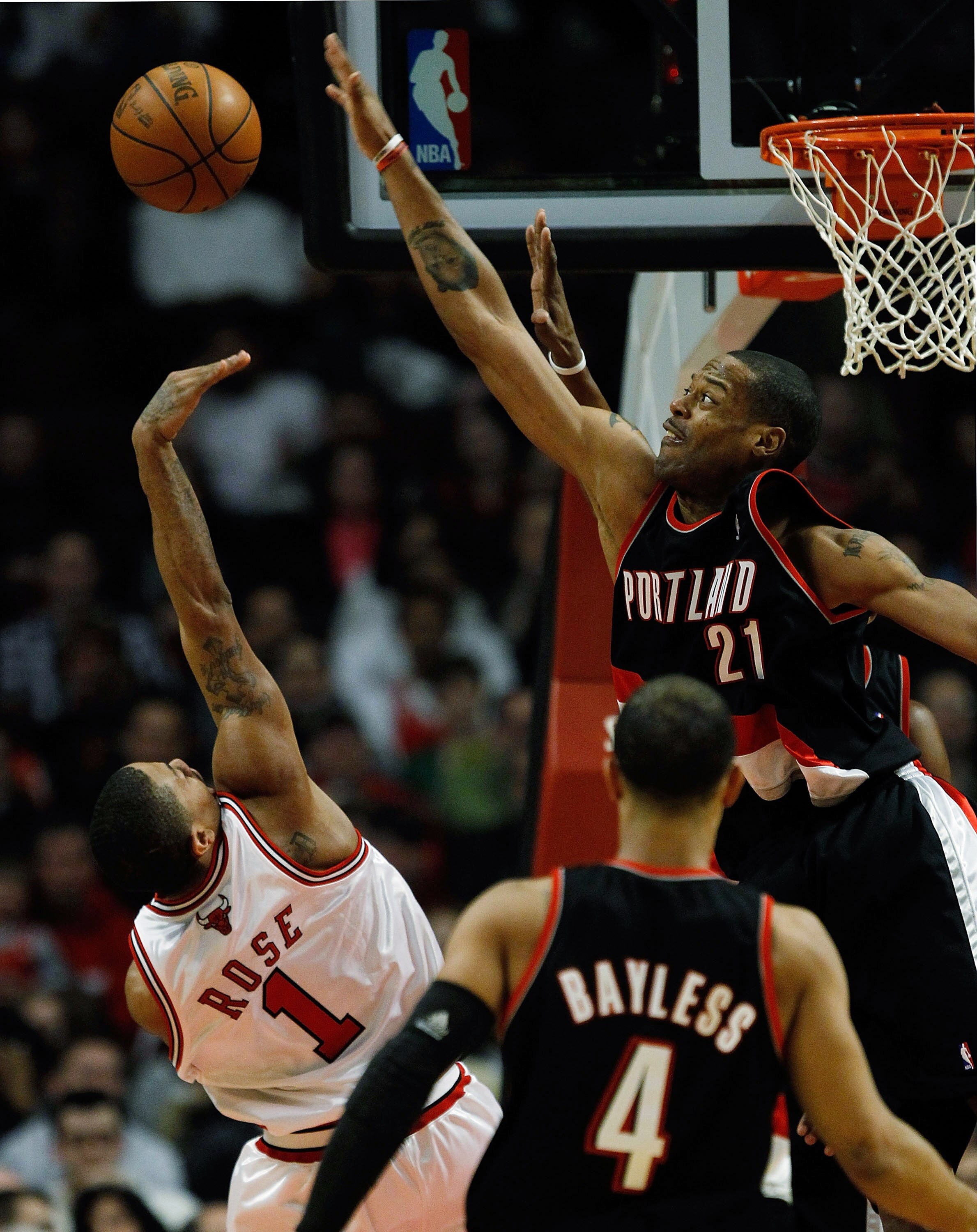 CHICAGO - FEBRUARY 26: Marcus Camby #21 of the Portland Trail Blazers blocks a shot by Derrick Rose #1 of the Chicago Bulls at the United Center on February 26, 2010 in Chicago, Illinois. NOTE TO USER: User expressly acknowledges and agrees that, by downl