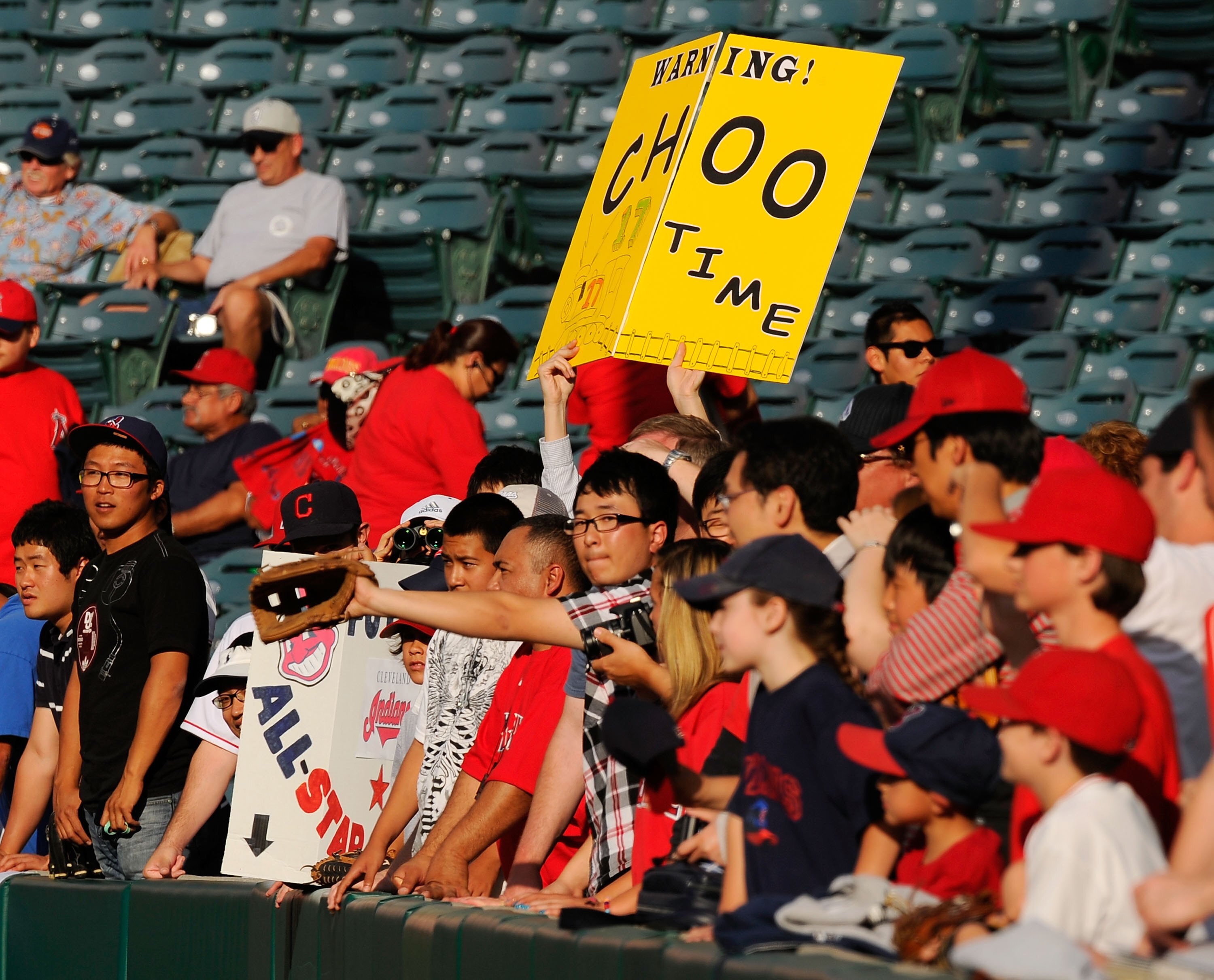 ANAHEIM, CA - APRIL 26:  Fans in support of Shin-Soo Choo #17 Korean right fielder of the Cleveland Indians hold up signs during batting practice before the start of the baseball game against Los Angeles Angels of Anaheim on April 26, 2010 at Angel Stadiu