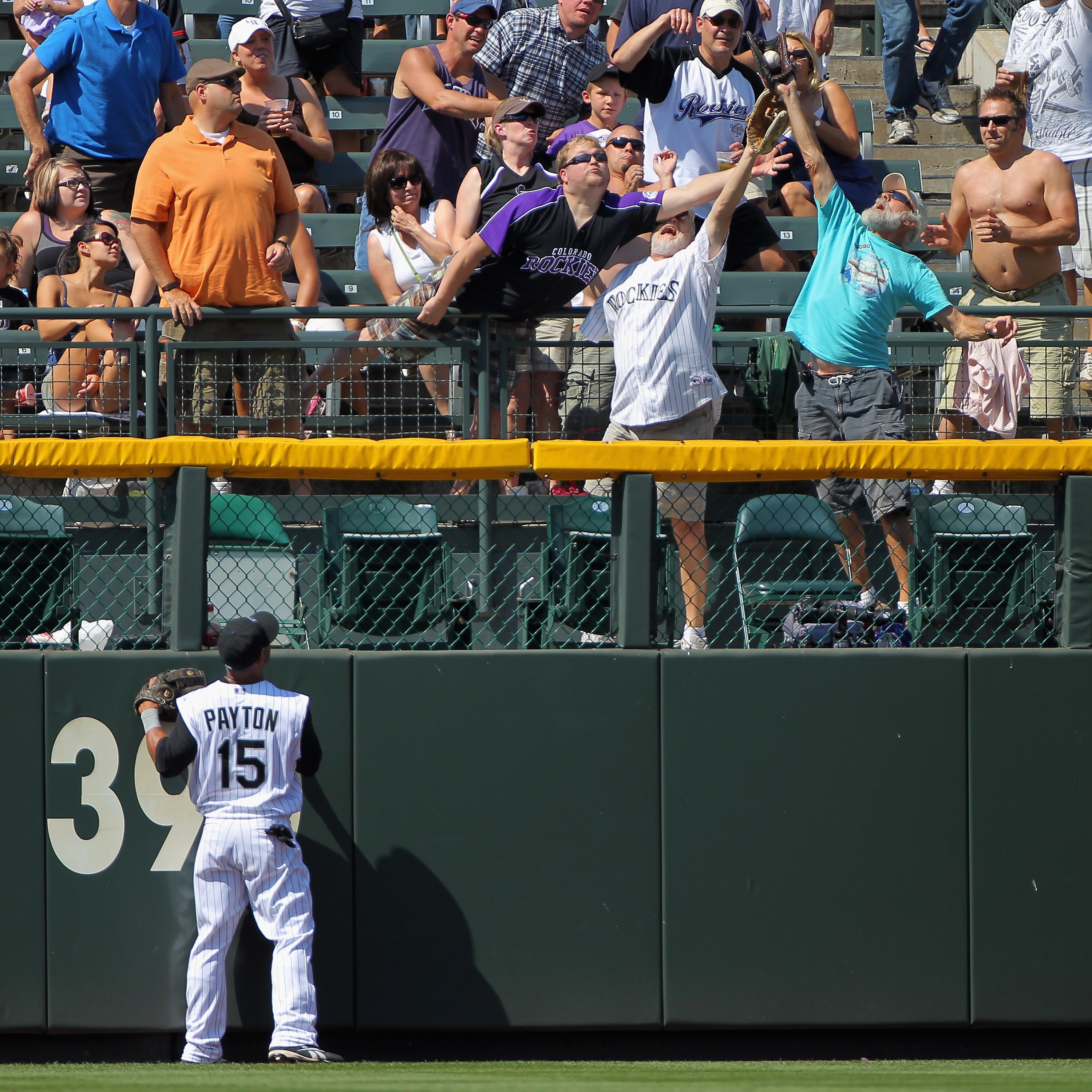 DENVER - SEPTEMBER 15:  Left fielder Jay Payton #15 of the Colorado Rockies can only watch as a fan catches a home run ball hit by Yorvit Torrealba of the San Diego Padres in the third inning at Coors Field on September 15, 2010 in Denver, Colorado.  (Pho