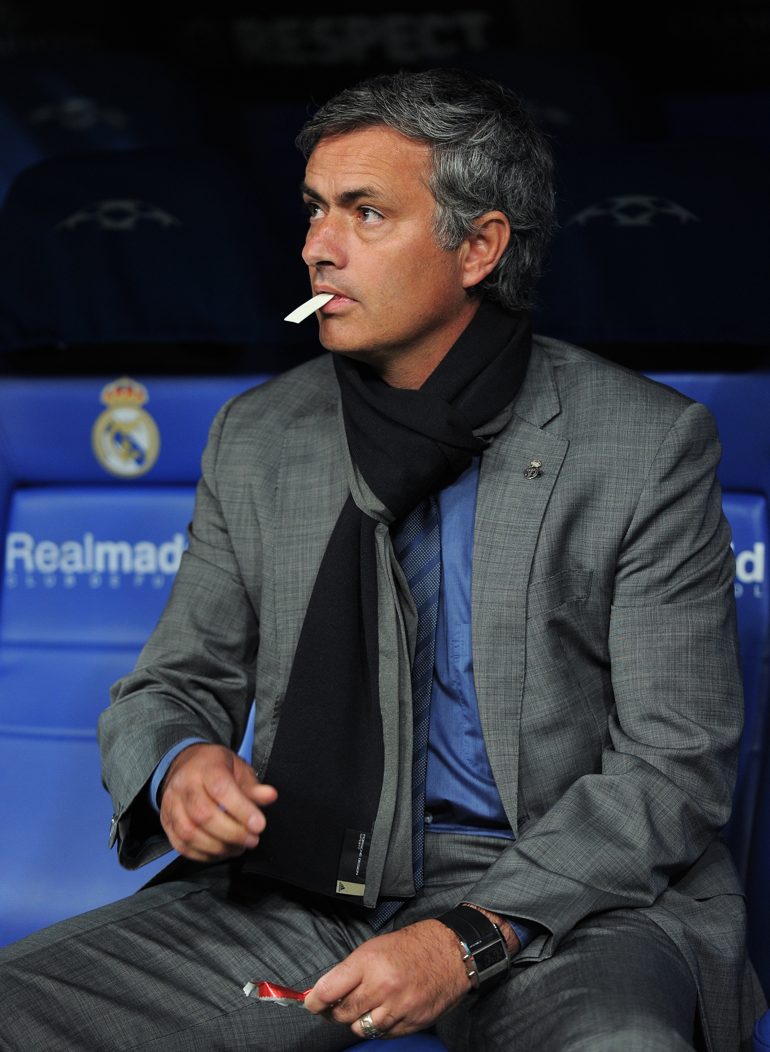 MADRID, SPAIN - OCTOBER 19:  Head coach Jose Mourinho of Real Madrid eats a piece of chewing gum while seated on the bench prior to the start of the UEFA Champions League group G match between Real Madrid and AC Milan at the Estadio Santiago Bernabeu on O