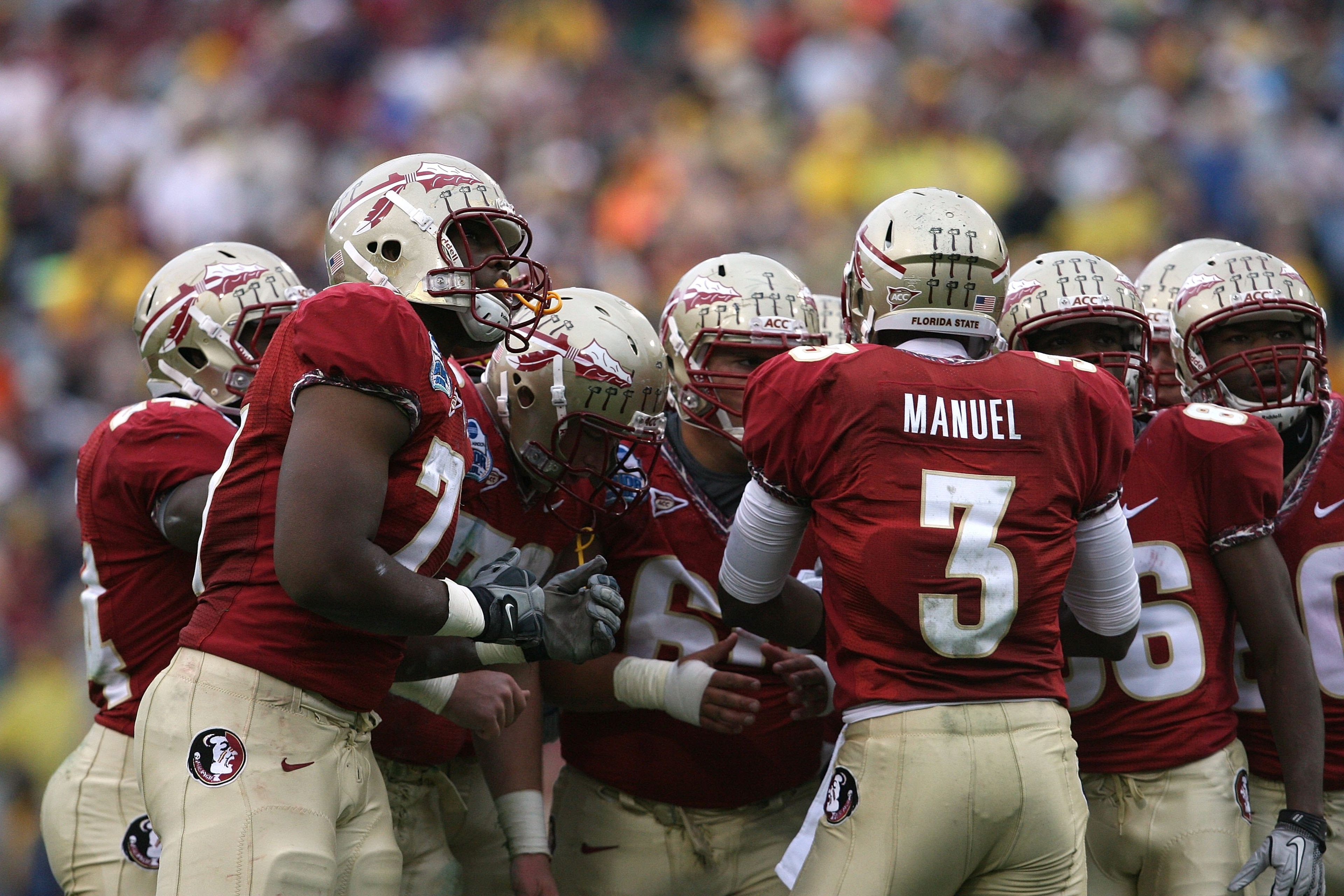 JACKSONVILLE, FL - JANUARY 01:  Quarterback E.J. Manuel #3 of the Florida State Seminoles calls out a play in the huddle against the West Virginia Mountaineers during the Konica Minolta Gator Bowl on January 1, 2010 at Jacksonville Municipal Stadium in Ja