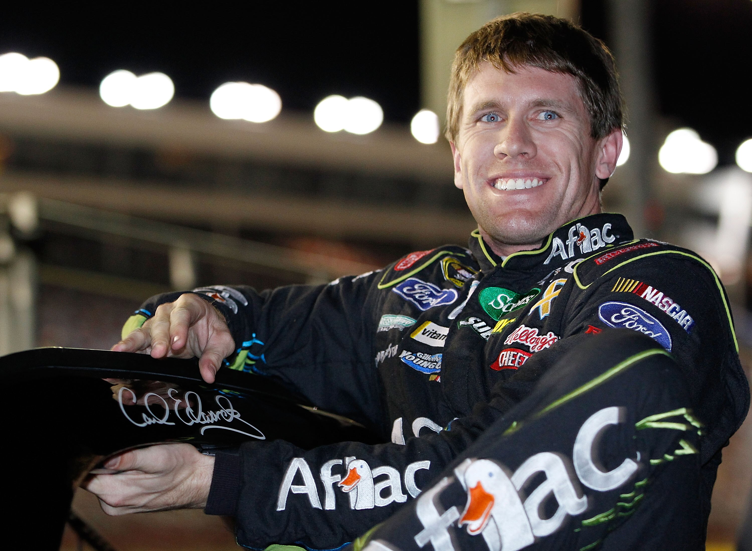 CONCORD, NC - OCTOBER 14:  Carl Edwards, driver of the #99 Aflac Ford, climbs out of his car after qualifying for the NASCAR Sprint Cup Series Bank of America 500 at Charlotte Motor Speedway on October 14, 2010 in Concord, North Carolina.  (Photo by Geoff