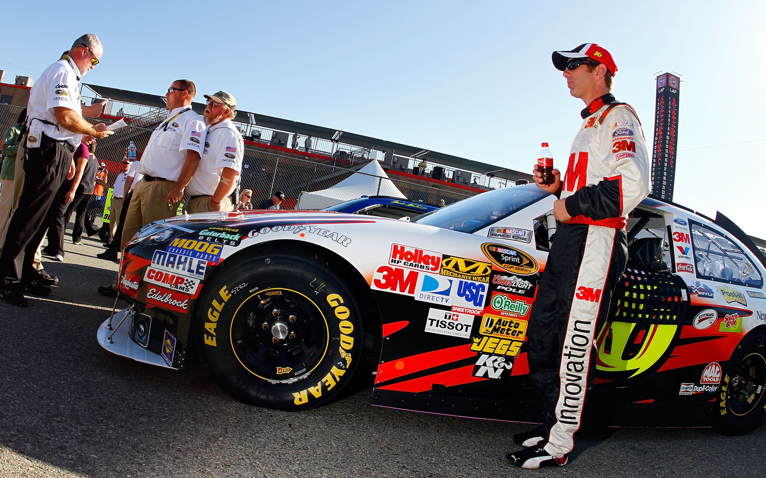 FONTANA, CA - OCTOBER 08:  Greg Biffle, driver of the #16 3M Ford, stands by his car following qualifying for the NASCAR Sprint Cup Series Pepsi Max 400 on October 8, 2010 in Fontana, California.  (Photo by Jason Smith/Getty Images for NASCAR)