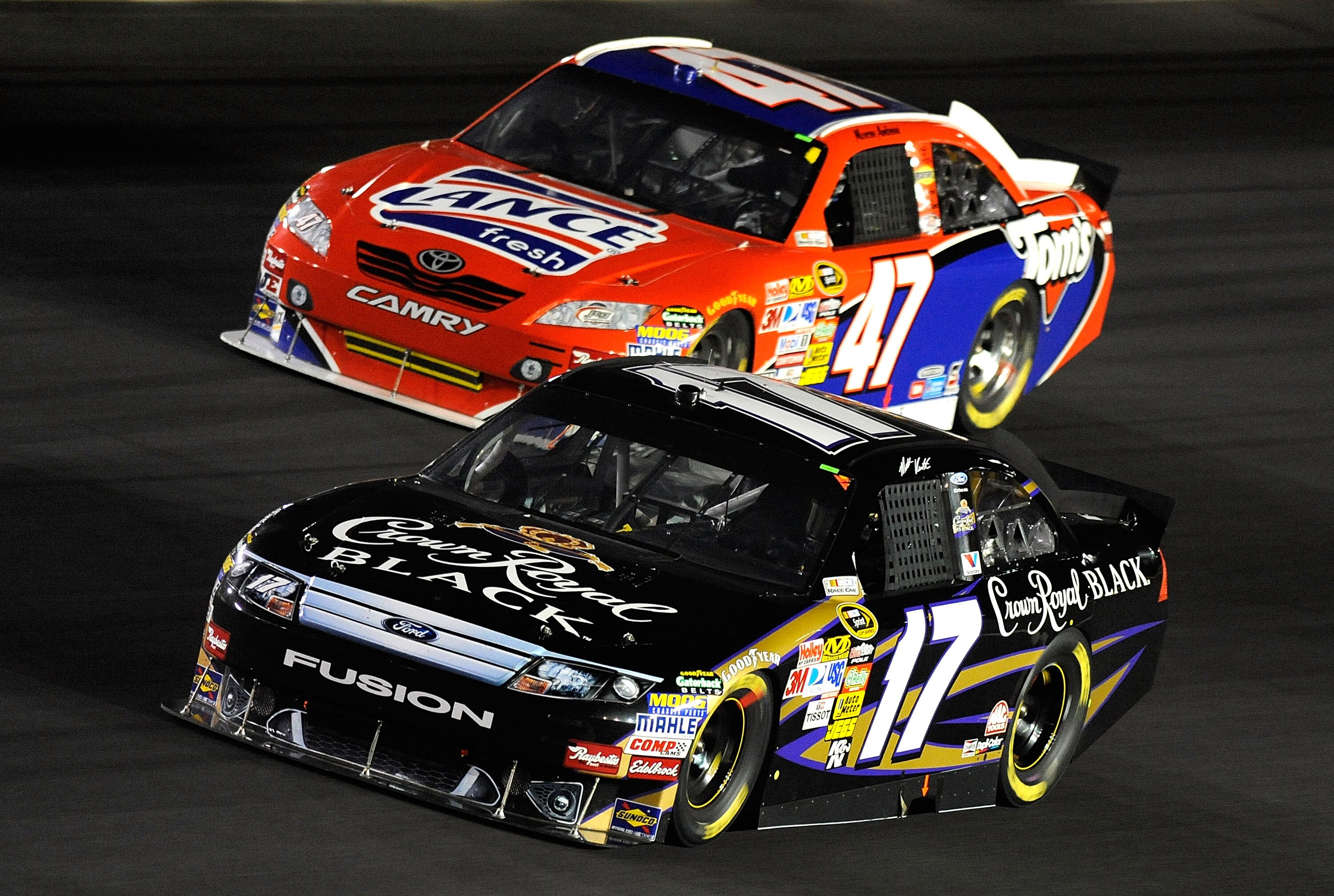 CONCORD, NC - OCTOBER 16:  Matt Kenseth, driver of the #17 Crown Royal Black Ford, races Marcos Ambrose, driver of the #47 Lance/Tom's Toyota, during the NASCAR Sprint Cup Series Bank of America 500 at Charlotte Motor Speedway on October 16, 2010 in Conco
