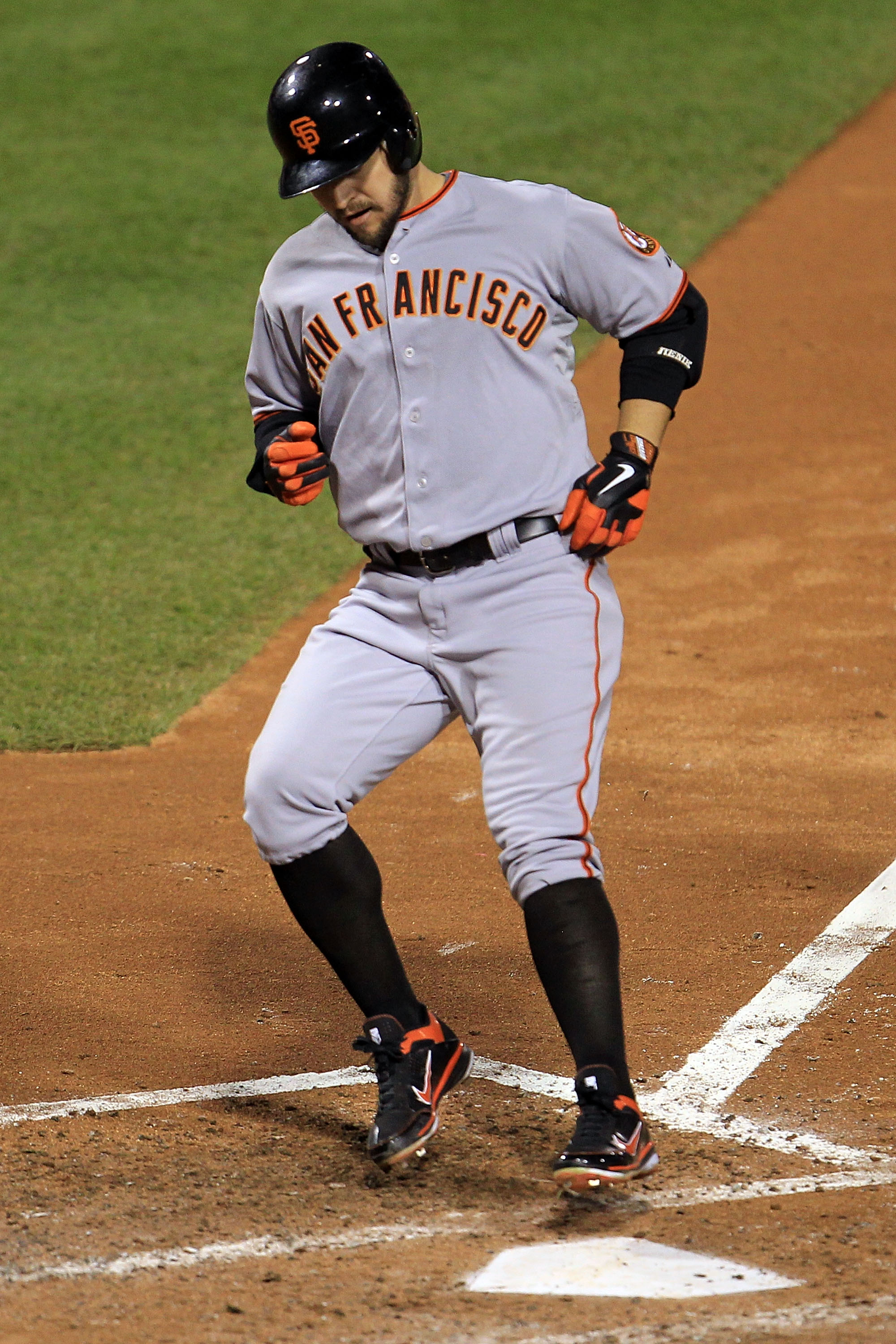 PHILADELPHIA - OCTOBER 17:  Cody Ross #13 of the San Francisco Giants touches home after he hits a solo home run in the fifth inning against the Philadelphia Phillies in Game Two of the NLCS during the 2010 MLB Playoffs at Citizens Bank Park on October 17