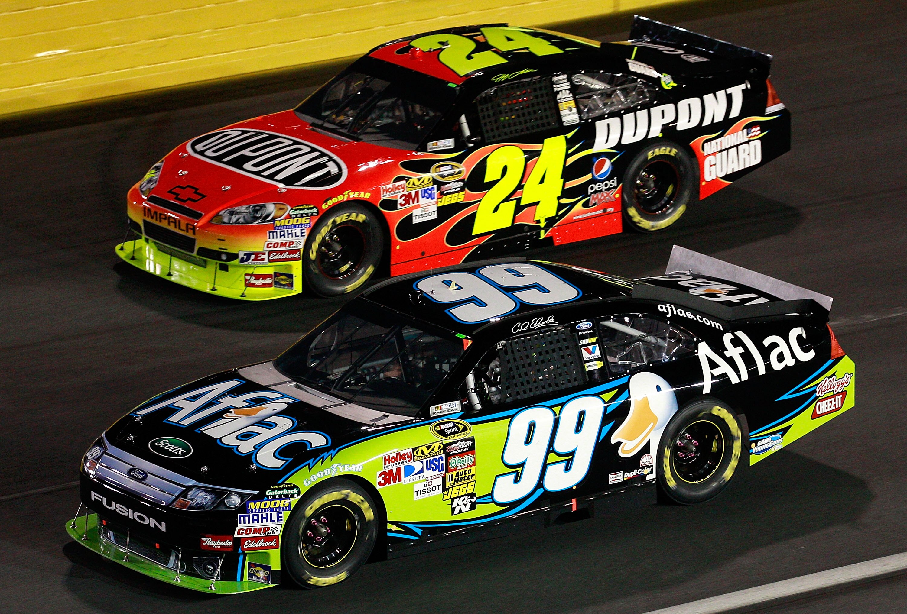 CONCORD, NC - OCTOBER 16:  Carl Edwards, driver of the #99 Aflac Ford, races Jeff Gordon, driver of the #24 DuPont Chevrolet, during the NASCAR Sprint Cup Series Bank of America 500 at Charlotte Motor Speedway on October 16, 2010 in Concord, North Carolin