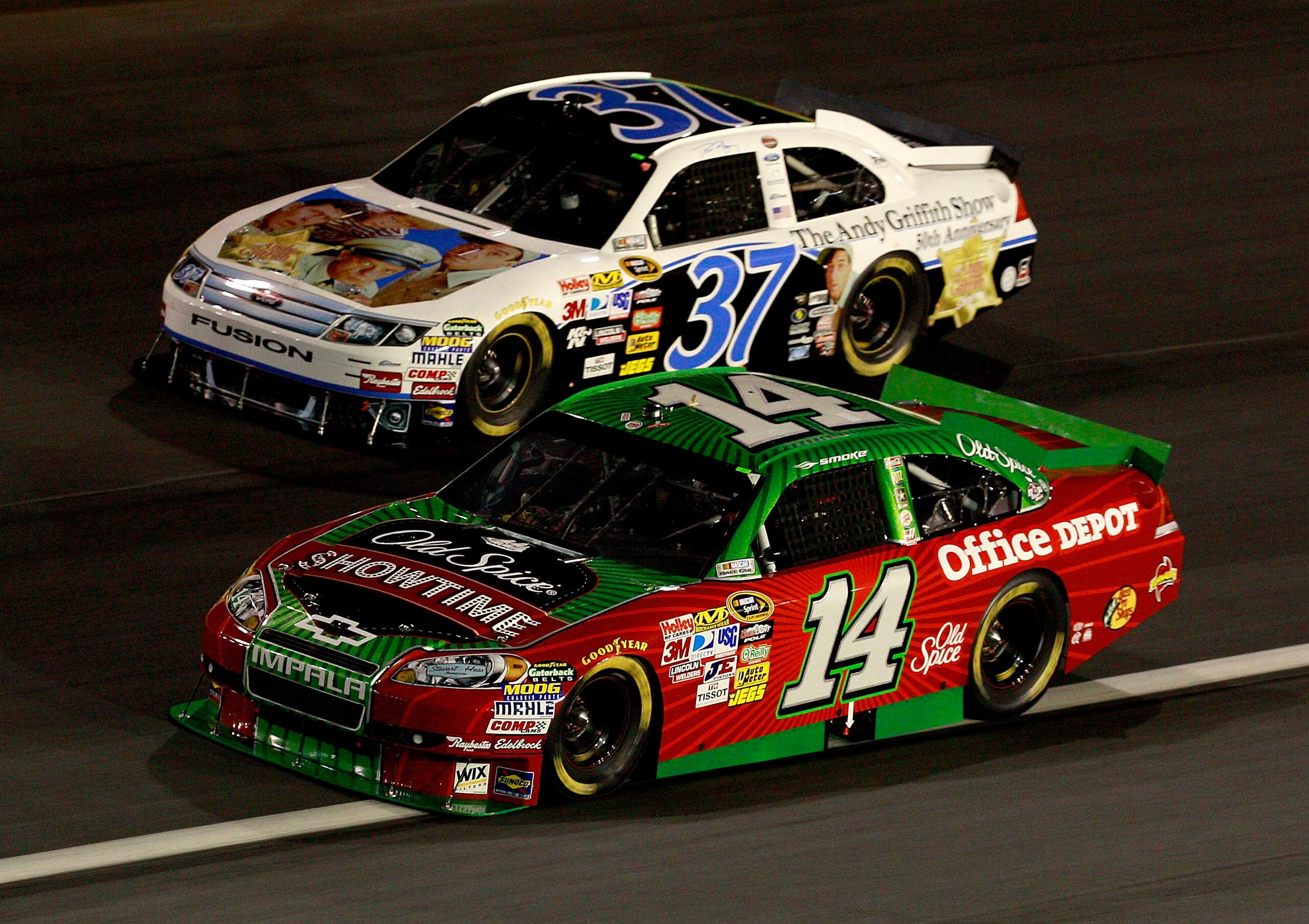 CONCORD, NC - OCTOBER 16:  Tony Stewart, driver of the #14 Old Spice/Office Depot Chevrolet, races Dave Blaney, driver of the #37  Andy Griffith Show 50th Anniversary Ford, during the NASCAR Sprint Cup Series Bank of America 500 at Charlotte Motor Speedwa