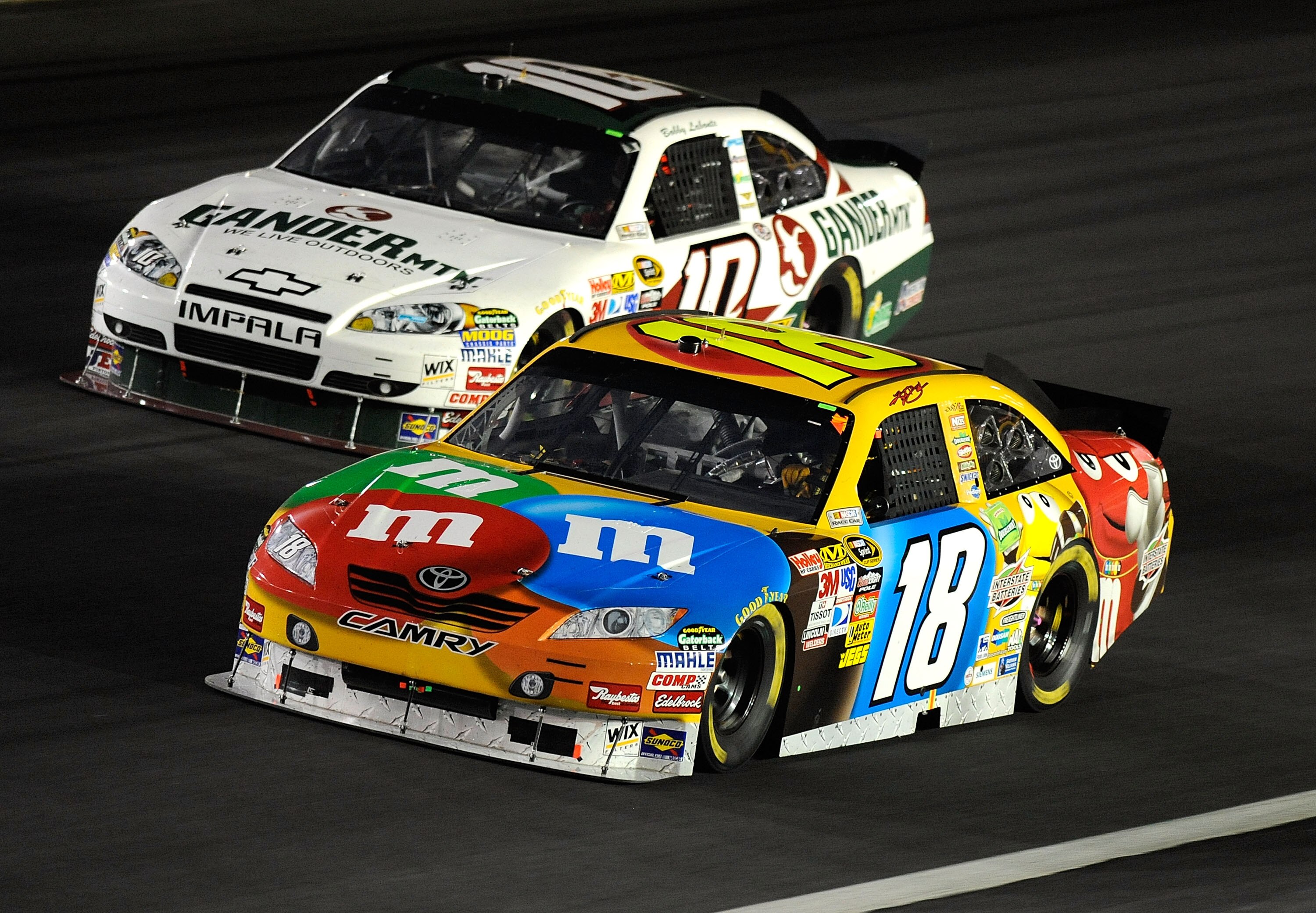 CONCORD, NC - OCTOBER 16:  Kyle Busch, driver of the #18 M&M's Toyota, races Bobby Labonte, driver of the #10 Gander Mountain Outdoors Chevrolet, during the NASCAR Sprint Cup Series Bank of America 500 at Charlotte Motor Speedway on October 16, 2010 in Co