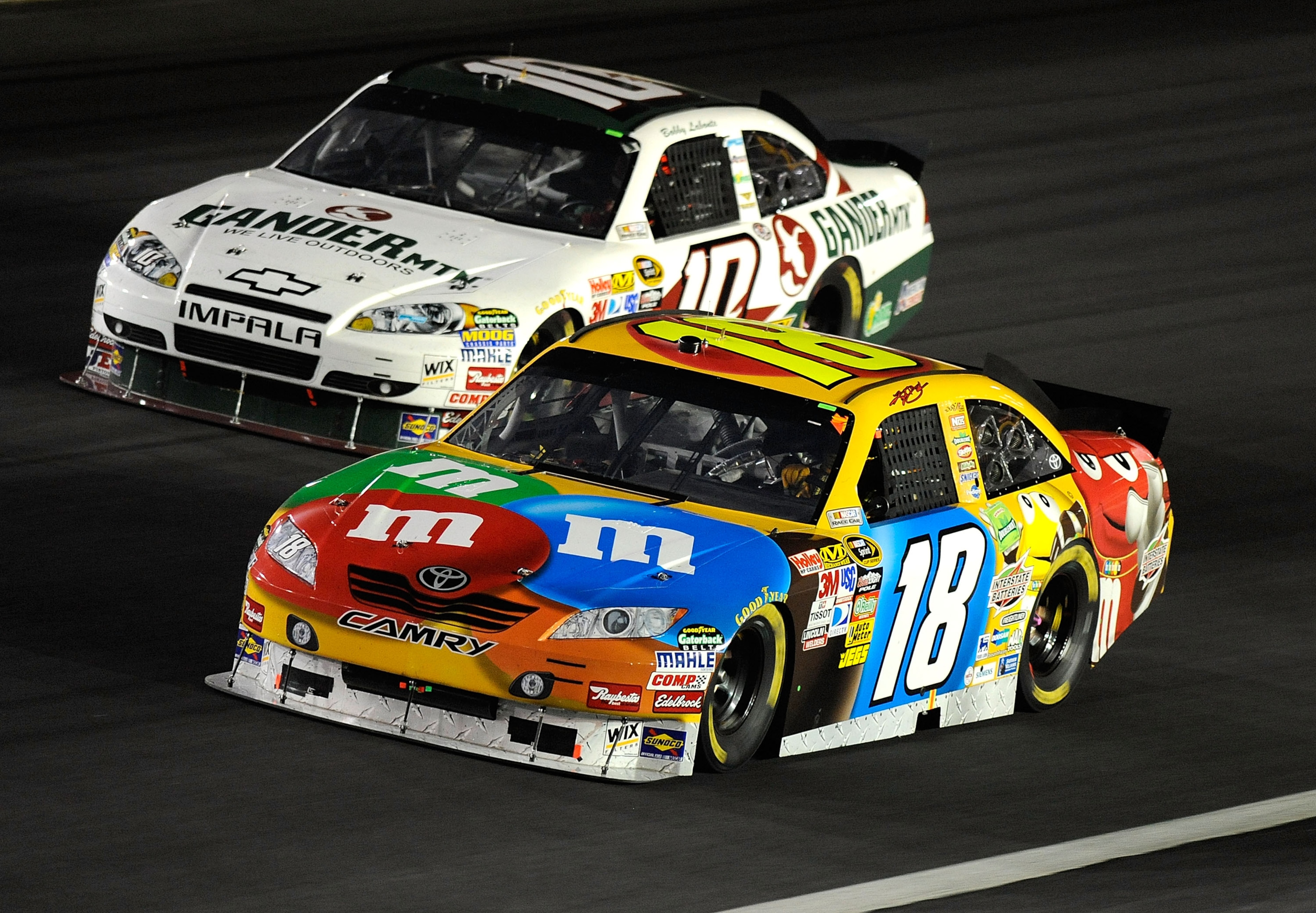 CONCORD, NC - OCTOBER 16:  Kyle Busch, driver of the #18 M&M's Toyota, races Bobby Labonte, driver of the #10 Gander Mountain Outdoors Chevrolet, during the NASCAR Sprint Cup Series Bank of America 500 at Charlotte Motor Speedway on October 16, 2010 in Co