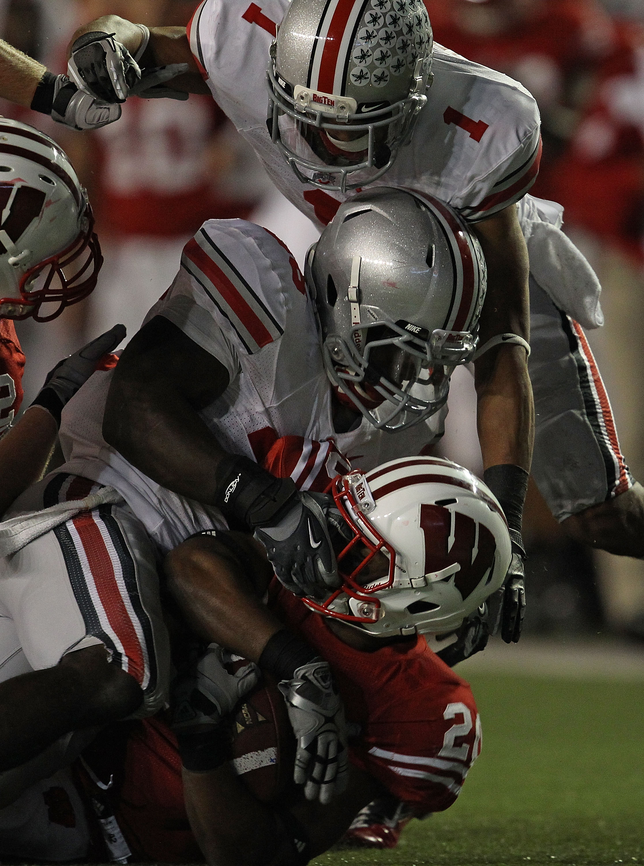 MADISON, WI - OCTOBER 16: James White #20 of the Wisconsin Badgers is tackled by the face mask by Brian Rolle #36 of the Ohio State Buckeyes as Devon Torrence # closes in at Camp Randall Stadium on October 16, 2010 in Madison, Wisconsin. Wisconsin defeate