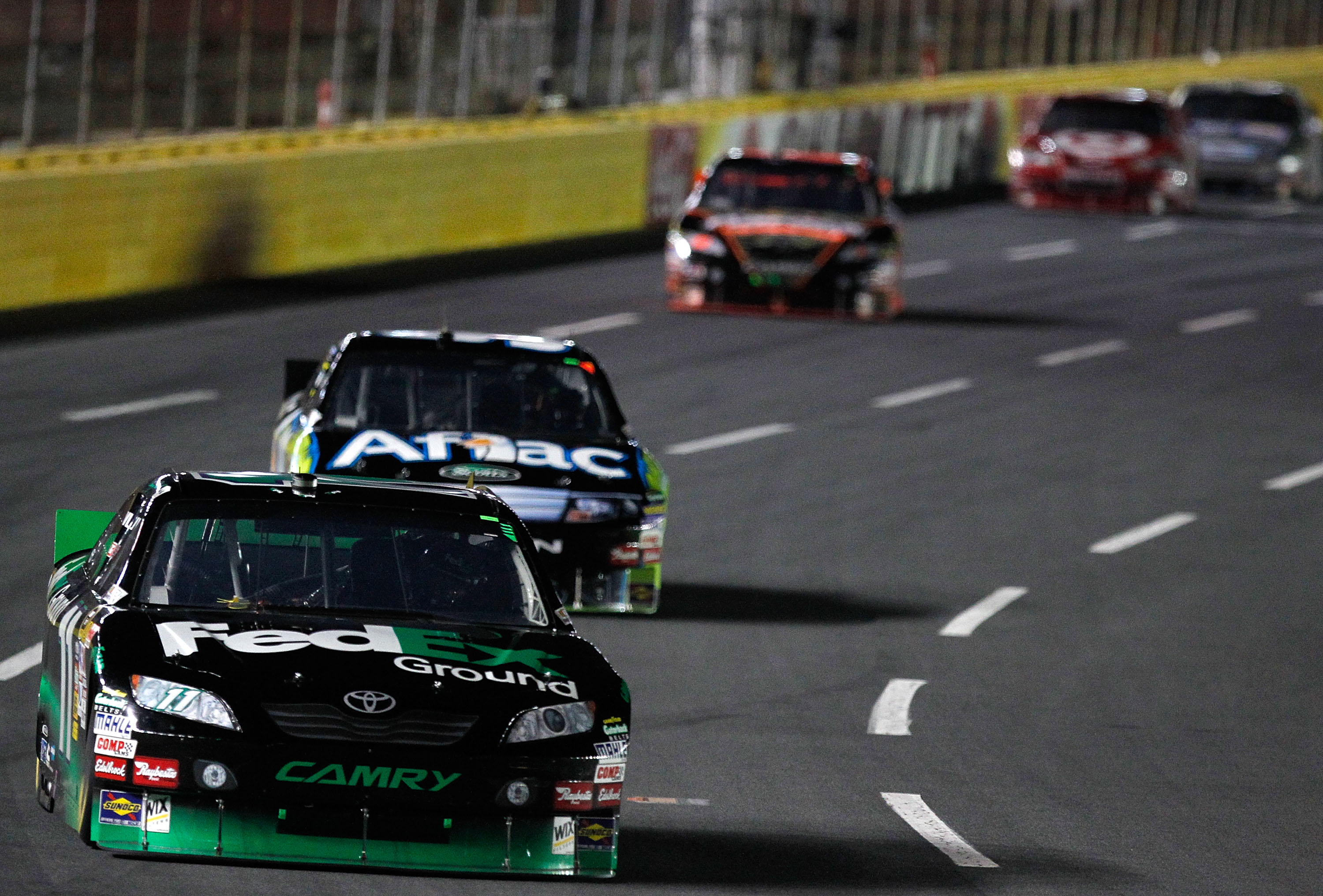 CONCORD, NC - OCTOBER 16:  Denny Hamlin, driver of the #11 FedEx Ground Toyota, races Carl Edwards, driver of the #99 Aflac Ford, during the NASCAR Sprint Cup Series Bank of America 500 at Charlotte Motor Speedway on October 16, 2010 in Concord, North Car