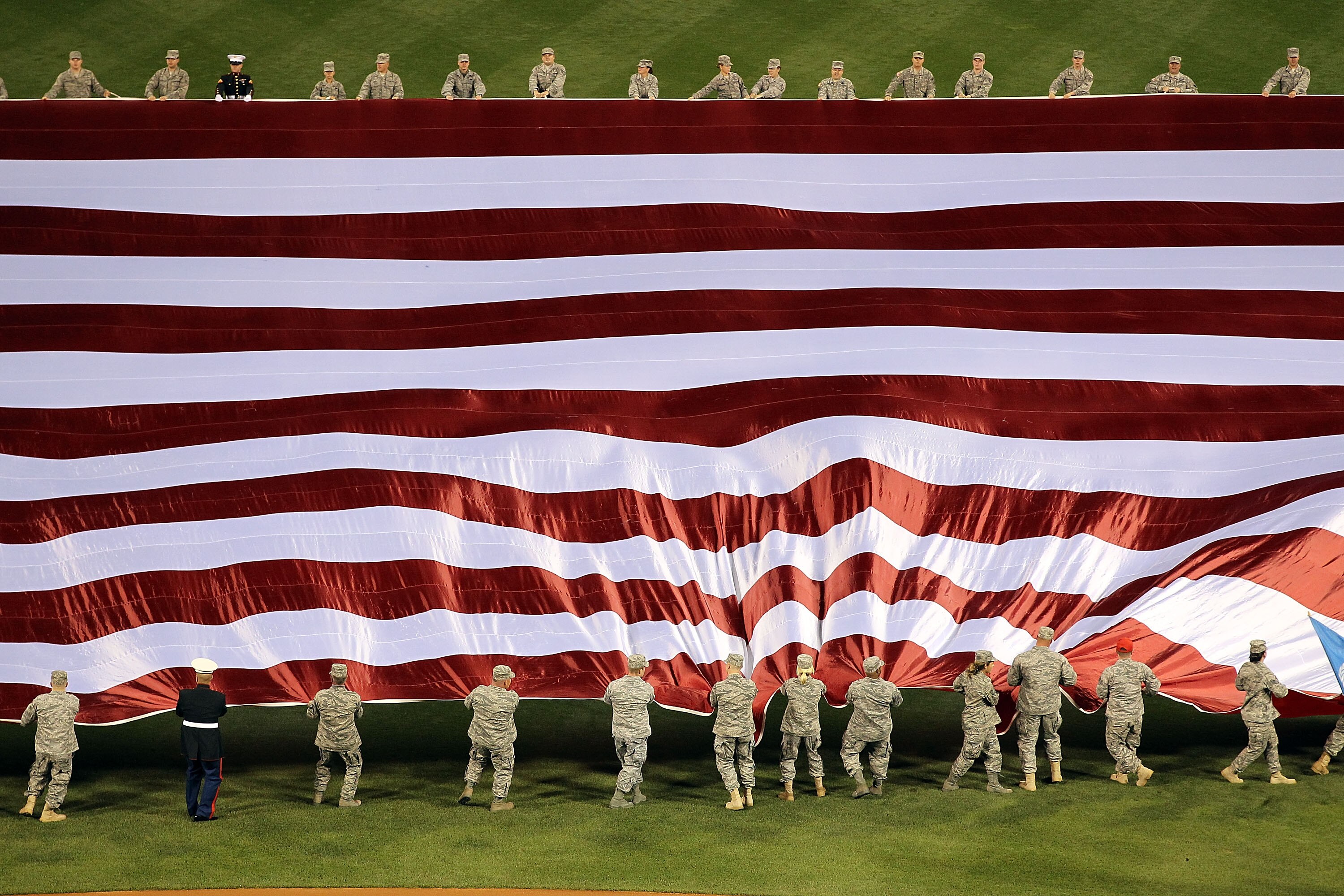 PHILADELPHIA - OCTOBER 16:  The American flag is displayed in the outfield during the singing of the national anthem before Game One of the NLCS during the 2010 MLB Playoffs between the San Francisco Giants and the Philadelphia Phillies at Citizens Bank P